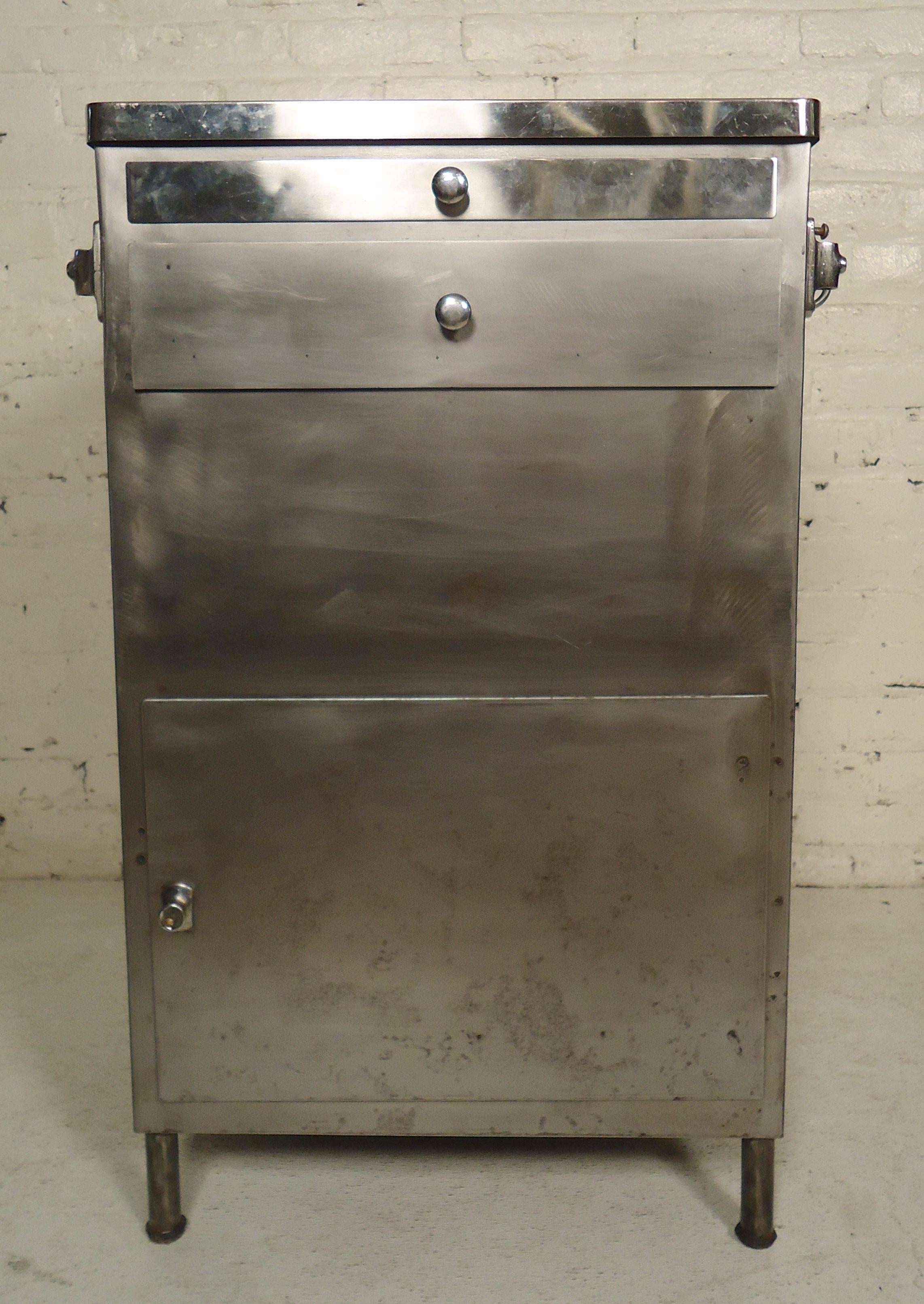 Refinished metal cabinet with extending tray, single drawer and cabinet storage.

(Please confirm item location - NY or NJ - with dealer).
 