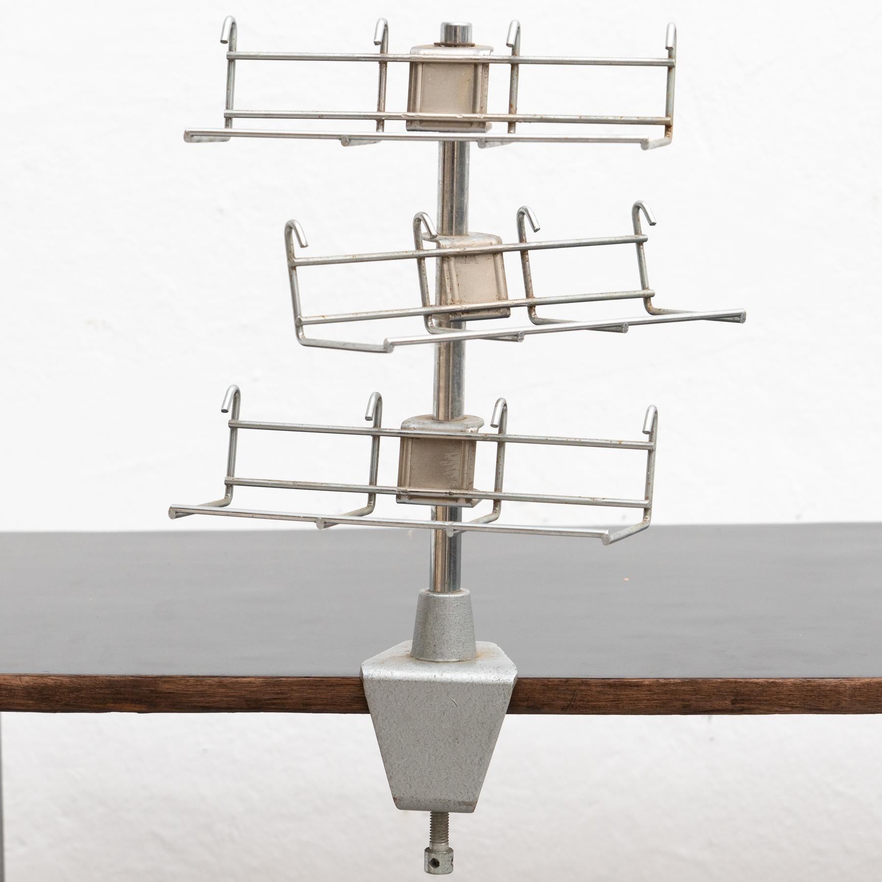 Industrial metal rotative display. With a table mount.  By Unknown Manufacturer circa 1970.    In original condition, with minor wear consistent of age and use, preserving a beautiful patina.    