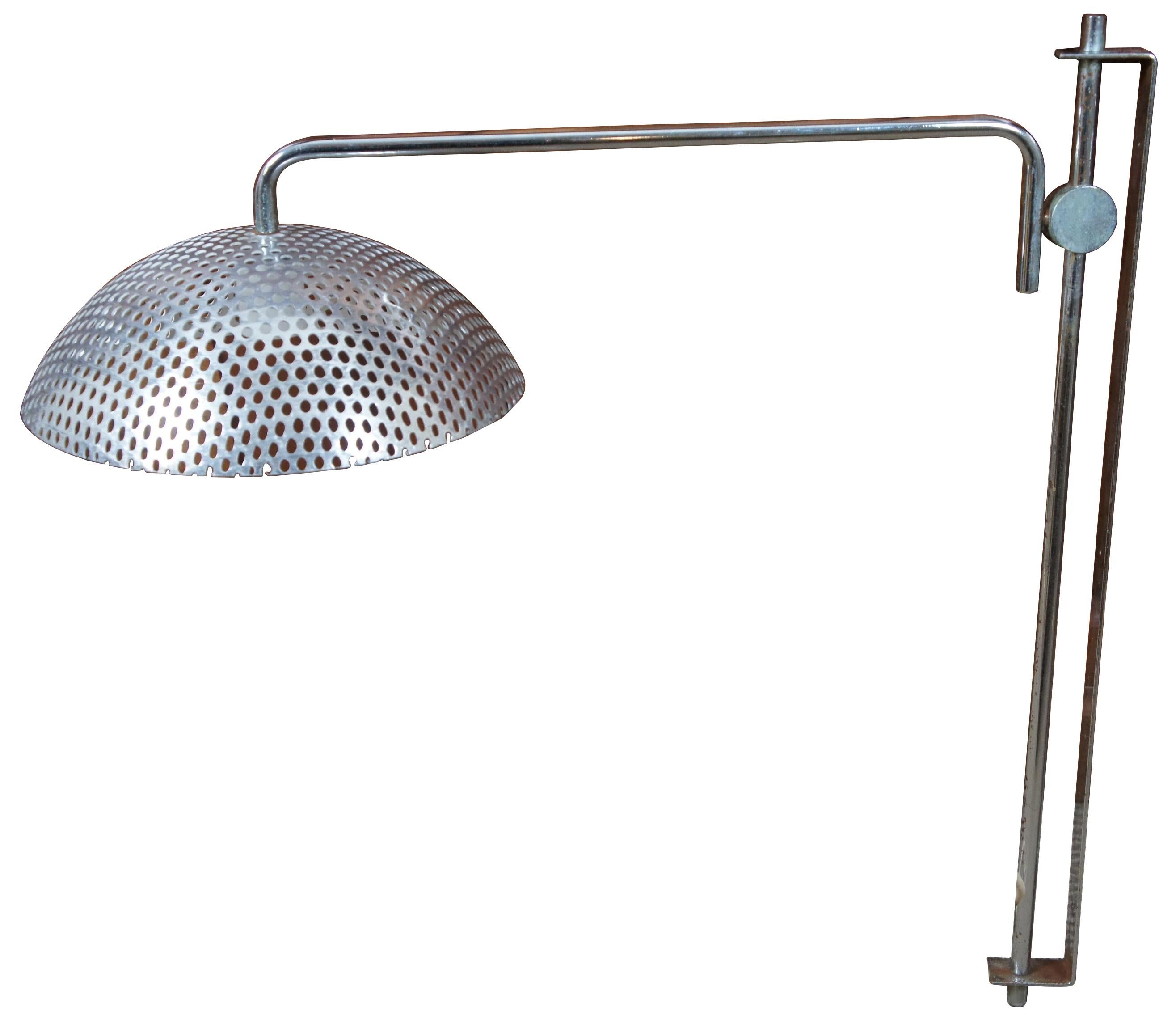 Vintage midcentury wall mounted, swiveling industrial style chrome and perforated steel work light.
   
