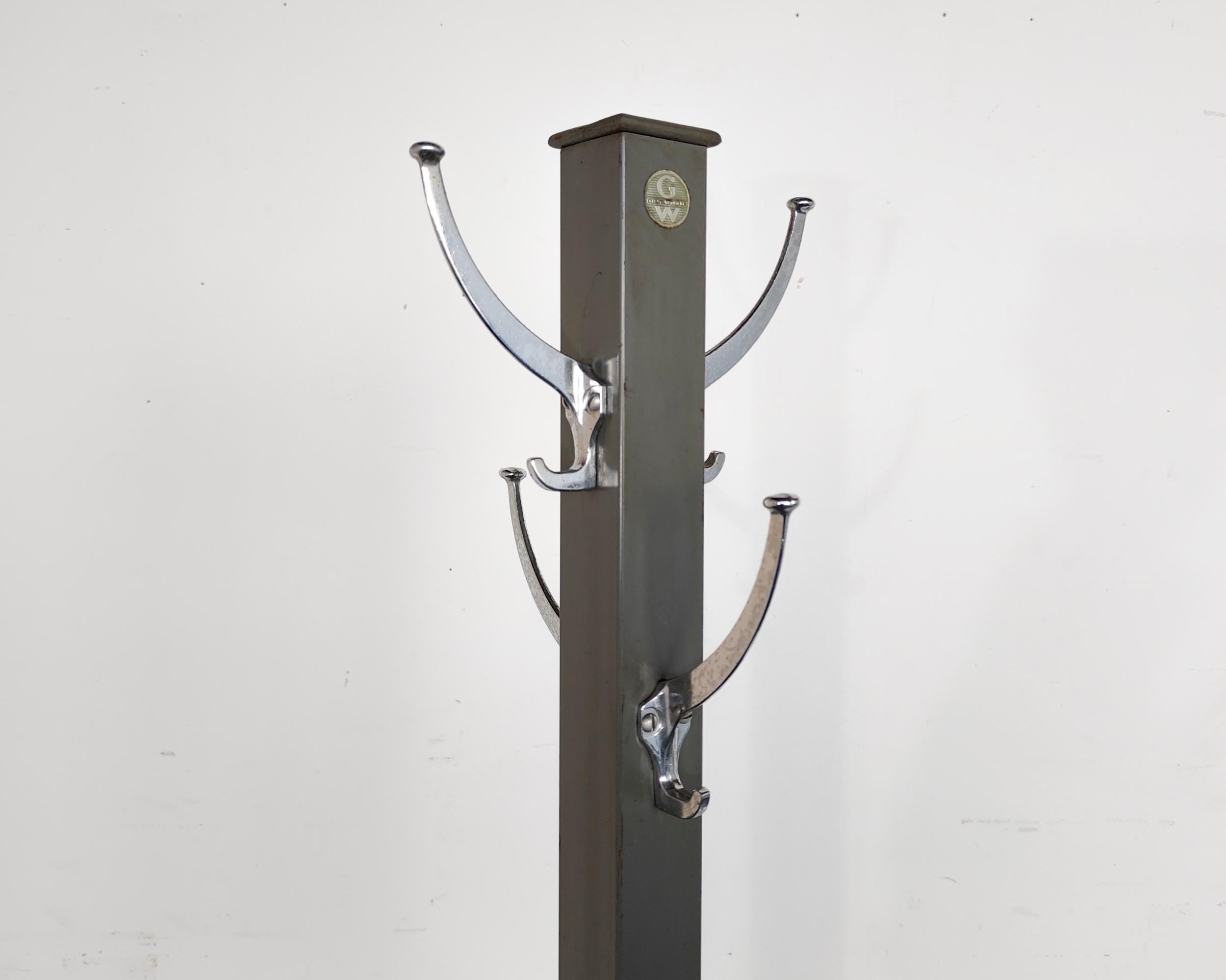 Midcentury Classic Industrial freestanding coat + hat stand. manufactured by Americas leading maker if Industrial and commercial furniture, Globe Wernicke. Enameled gray post and X-base and four chrome hooks. Original label still intact. Overall