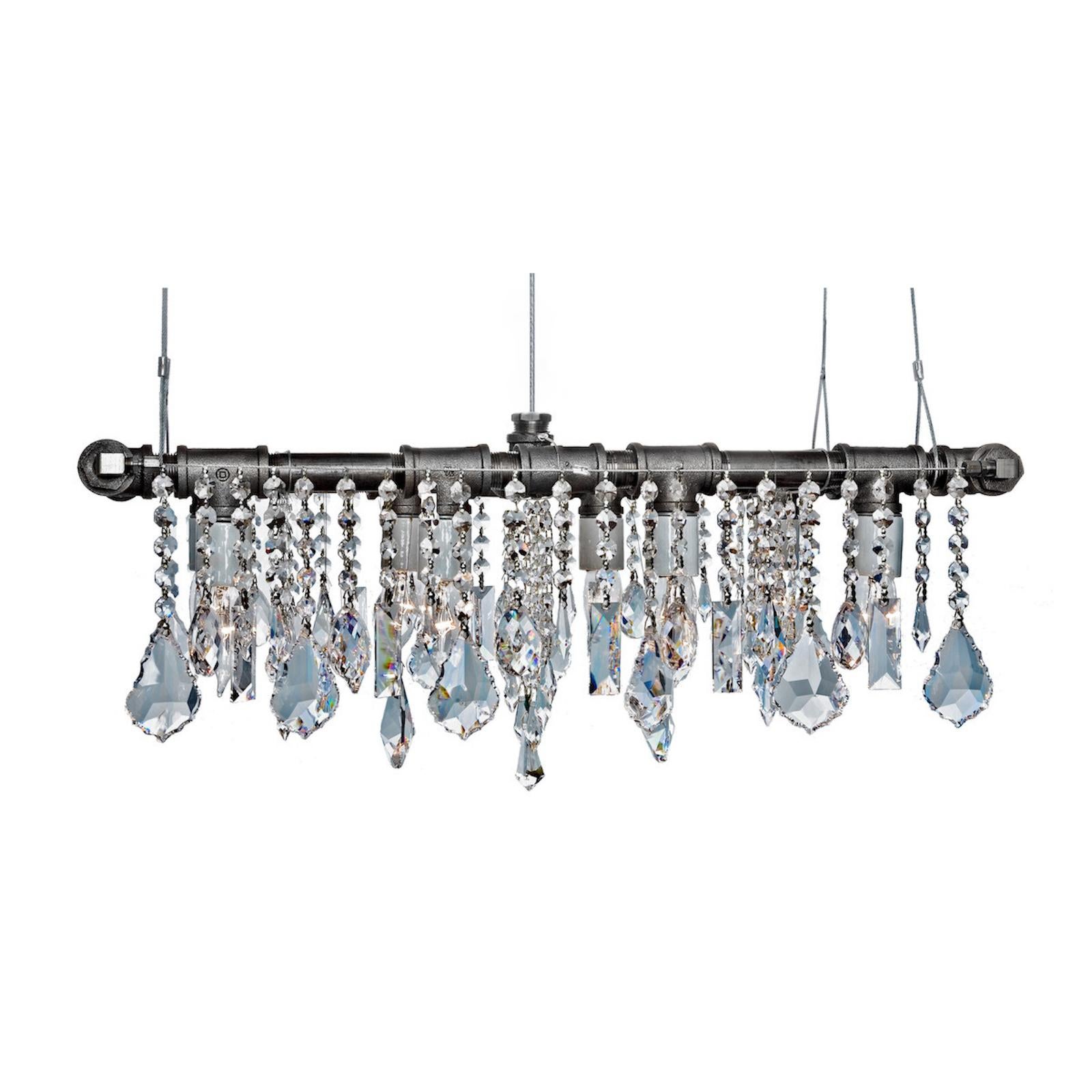 Industrial mini-banqueting linear suspension chandelier by Michael McHale.
Dimensions: D 27 x W 73.5 x H 25.5 cm.
Materials: steel, optically-pure gem-cut crystal.

8 x medium base CA7 bulb, either incandescent or LED.

All our lamps can be