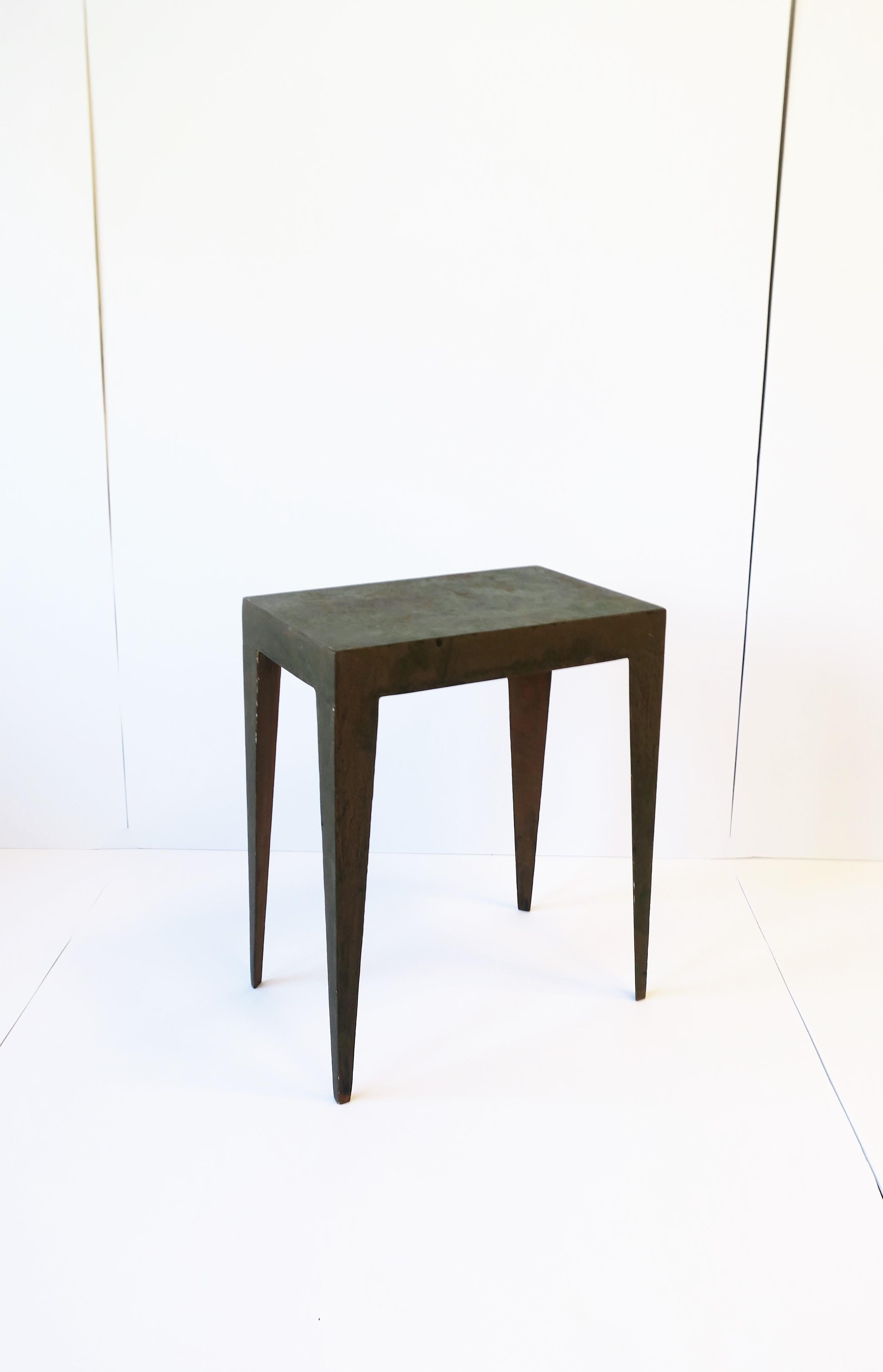 An Industrial / Minimalist metal side or end table with European Deco influence in legs. Table has an intentional weathered surface. Table is a convenient size. Dimensions: 8.38
