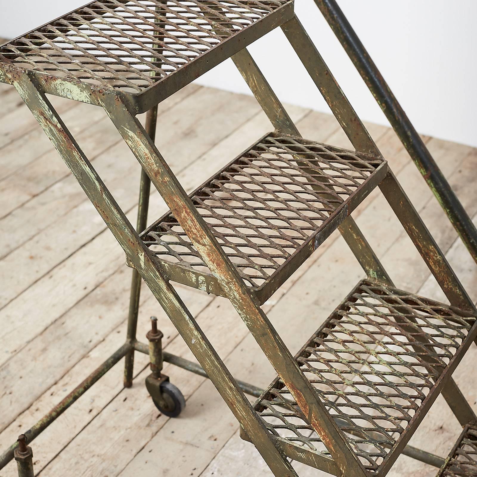 Steel framed ladder, on caster wheels.