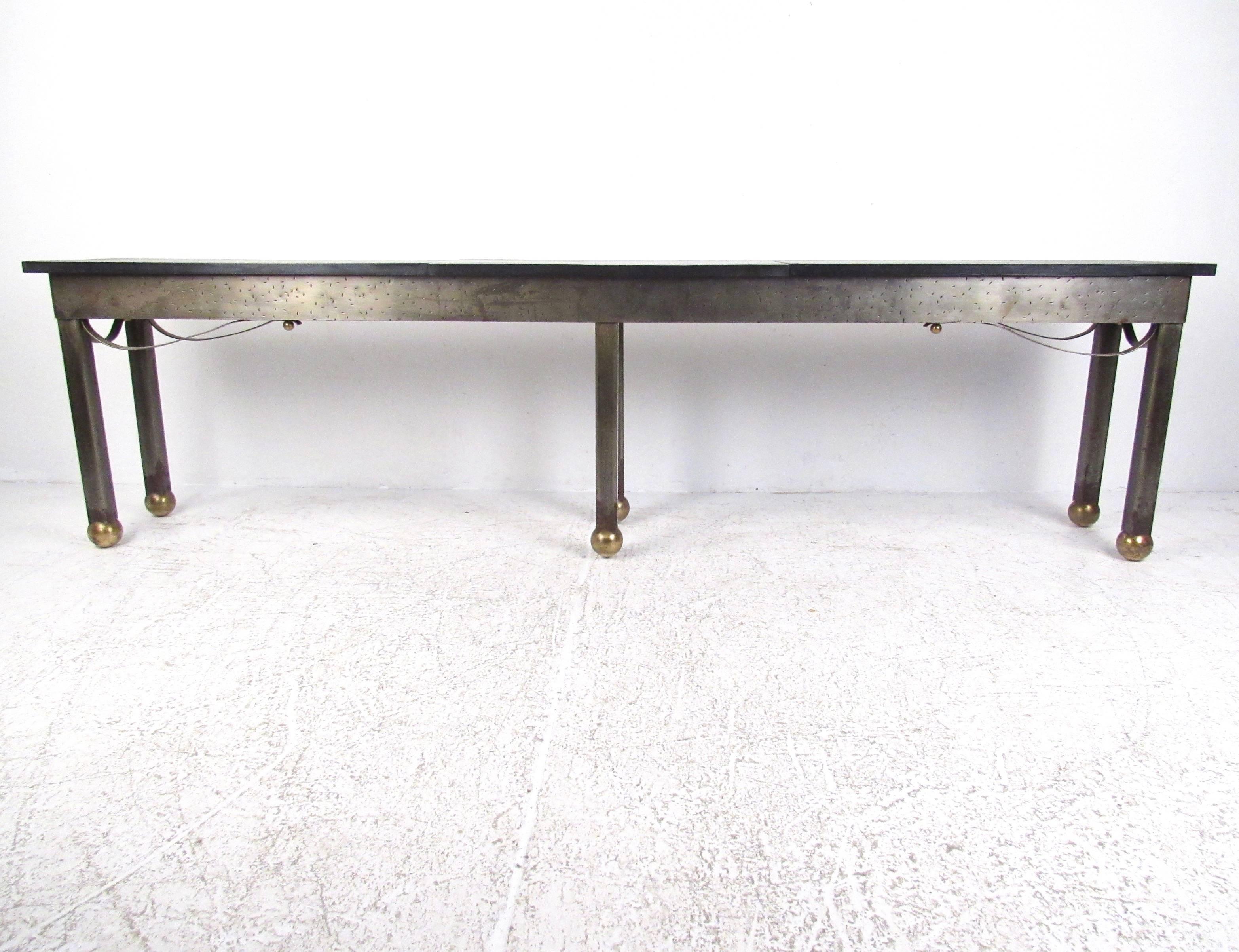 This impressive oversized console table features an industrial heavy steel base with a textured slate top and brass feet. Please confirm item location (NY or NJ).