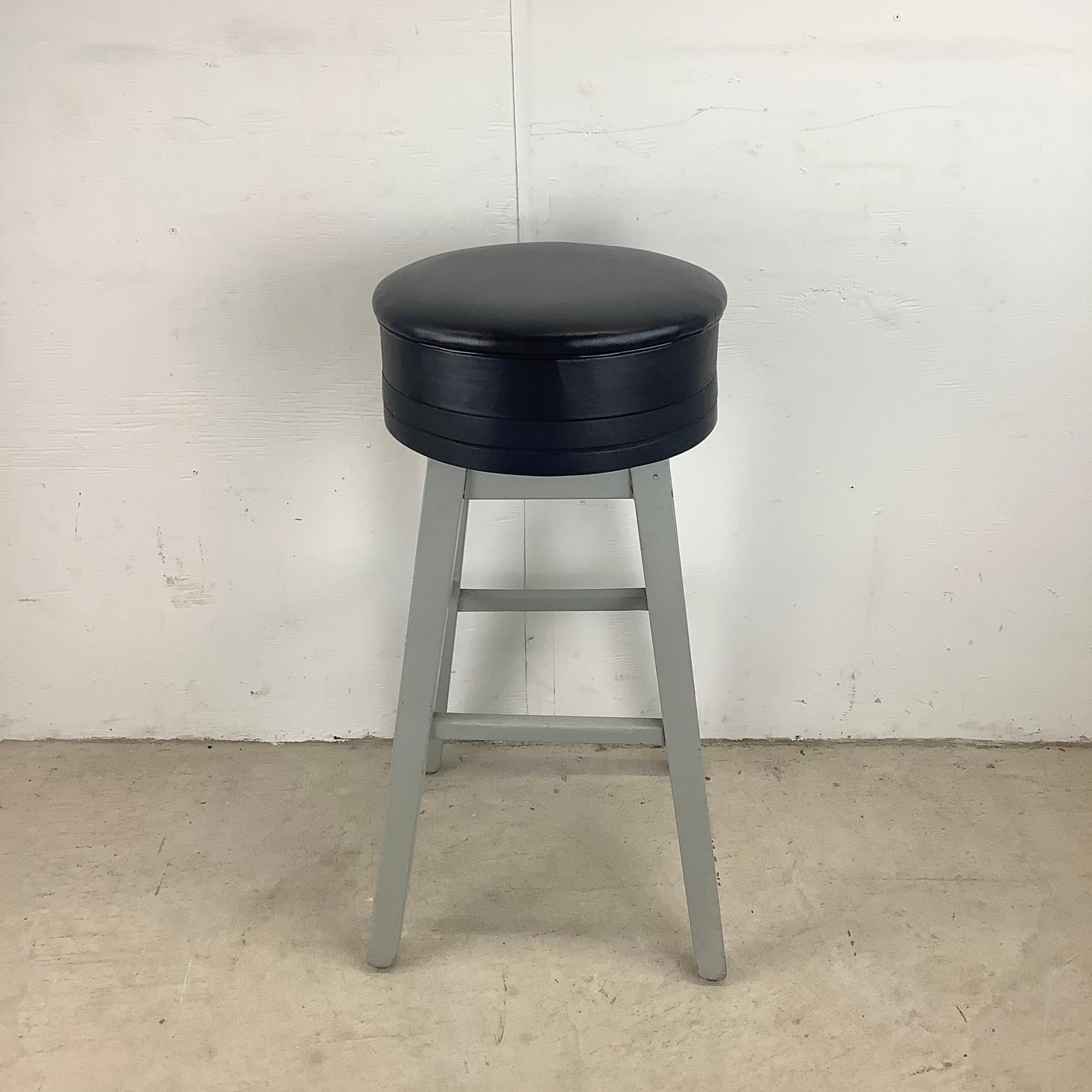 This simple industrial modern stool offers no frills occasional seating at unique workbench or counter height. Sturdy wooden frame and thick vinyl seat make this a utilitarian but comfortable addition to any workspace in need of stool