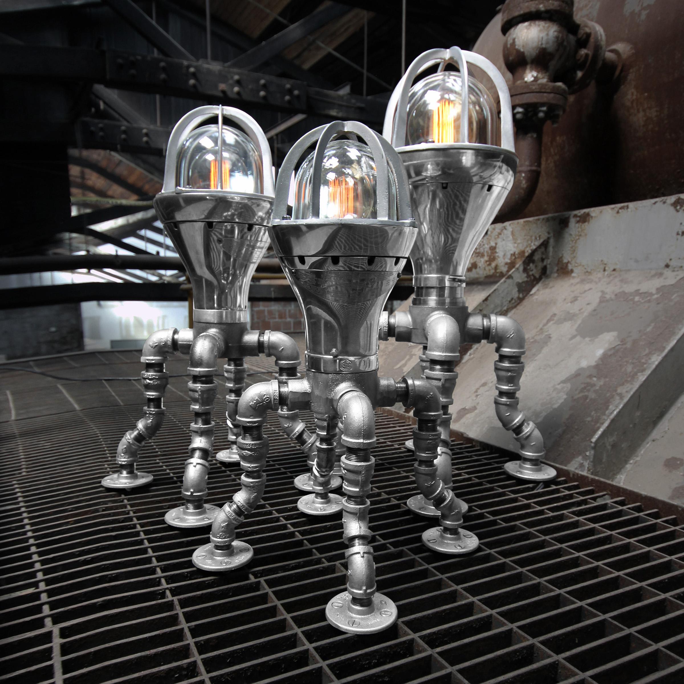 The Squids, a modern industrial lamp family,  are made from the only three sizes of a particular style of vintage Crouse Hinds factory light.  Add some personality and a serious focal point to your modern industrial interior design and use as a