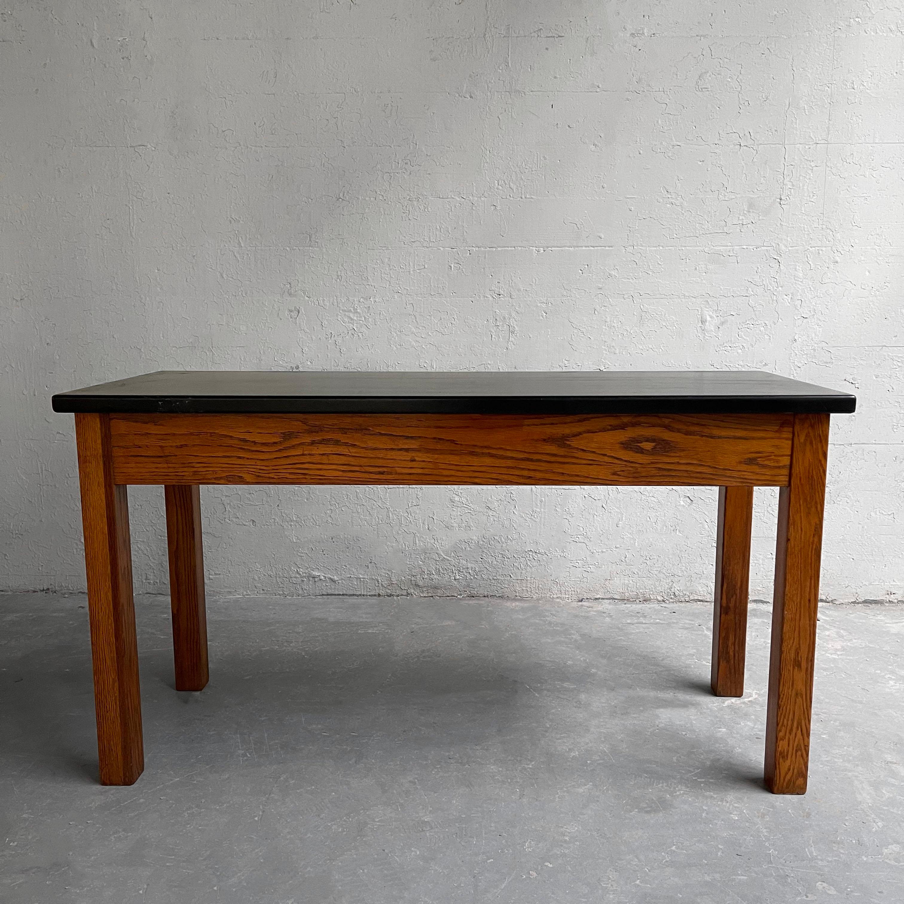 Midcentury, industrial, laboratory console table features an oak base with black, acid-resistant composite top for experiments. This piece makes a great console, slender desk or media table.