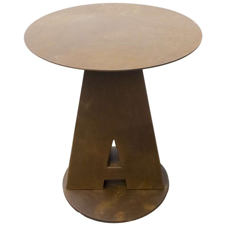 A fine example of reinterpretation and realization of an old Industrial element. Four big zinc letters from an American Circus A C P U have been reused as legs of four French Bistrot outdoor round tables, filled up of concrete. The top is made out