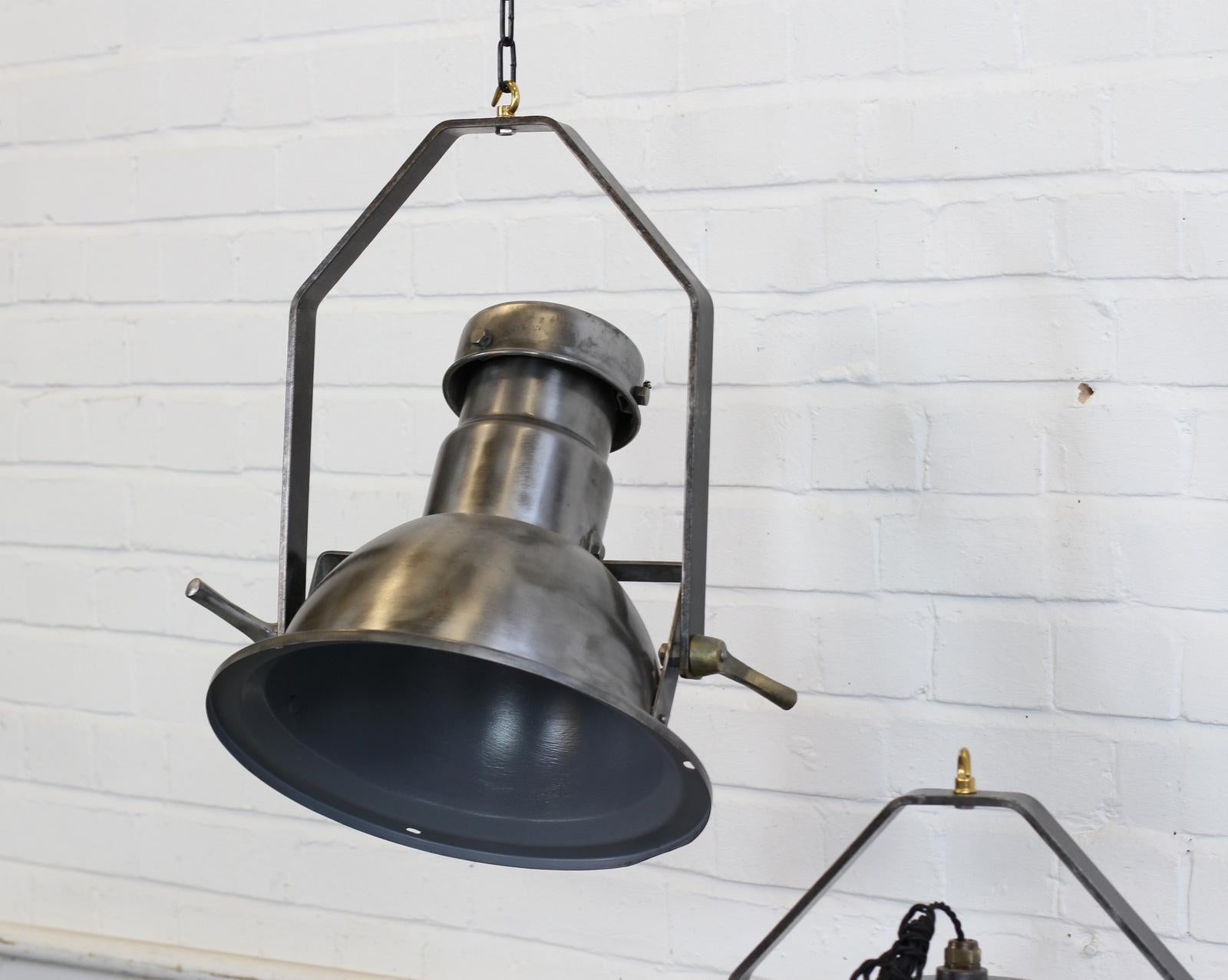 Industrial pendant lights by Holophane, circa 1950s.

- Price is per light
- Adjustable angle
- Steel shades and brackets
- Comes with 100cm of black twist flex 
- Comes with 100cm of suspension chain and ceiling hook
- Takes E27 fitting