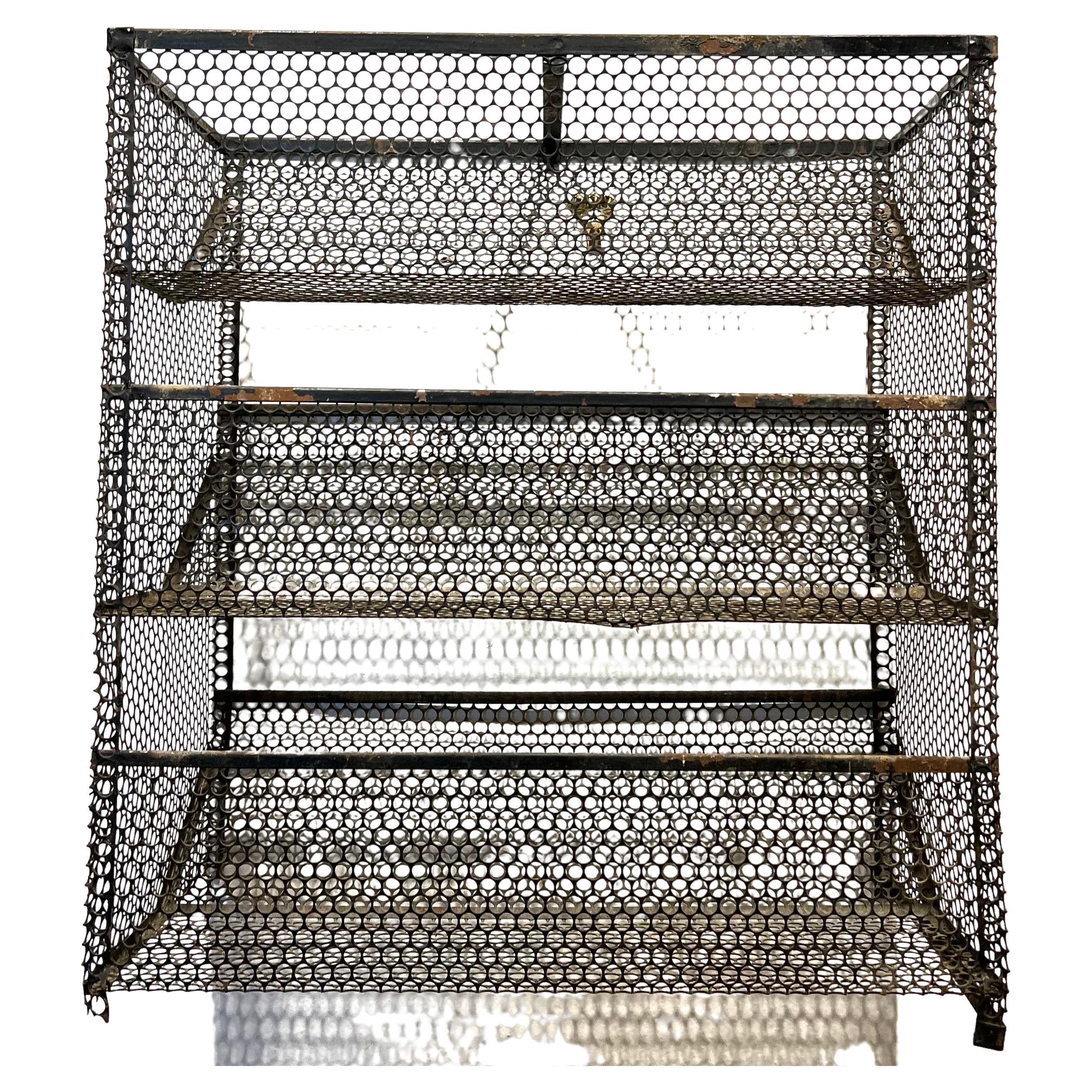 Cool perforated metal caddy, catch it all in original black enameled metal great for display smalls its missing one metal bottom stripe and some light bending and chips on the painting as is the original finish and patina. it can be hung or use on