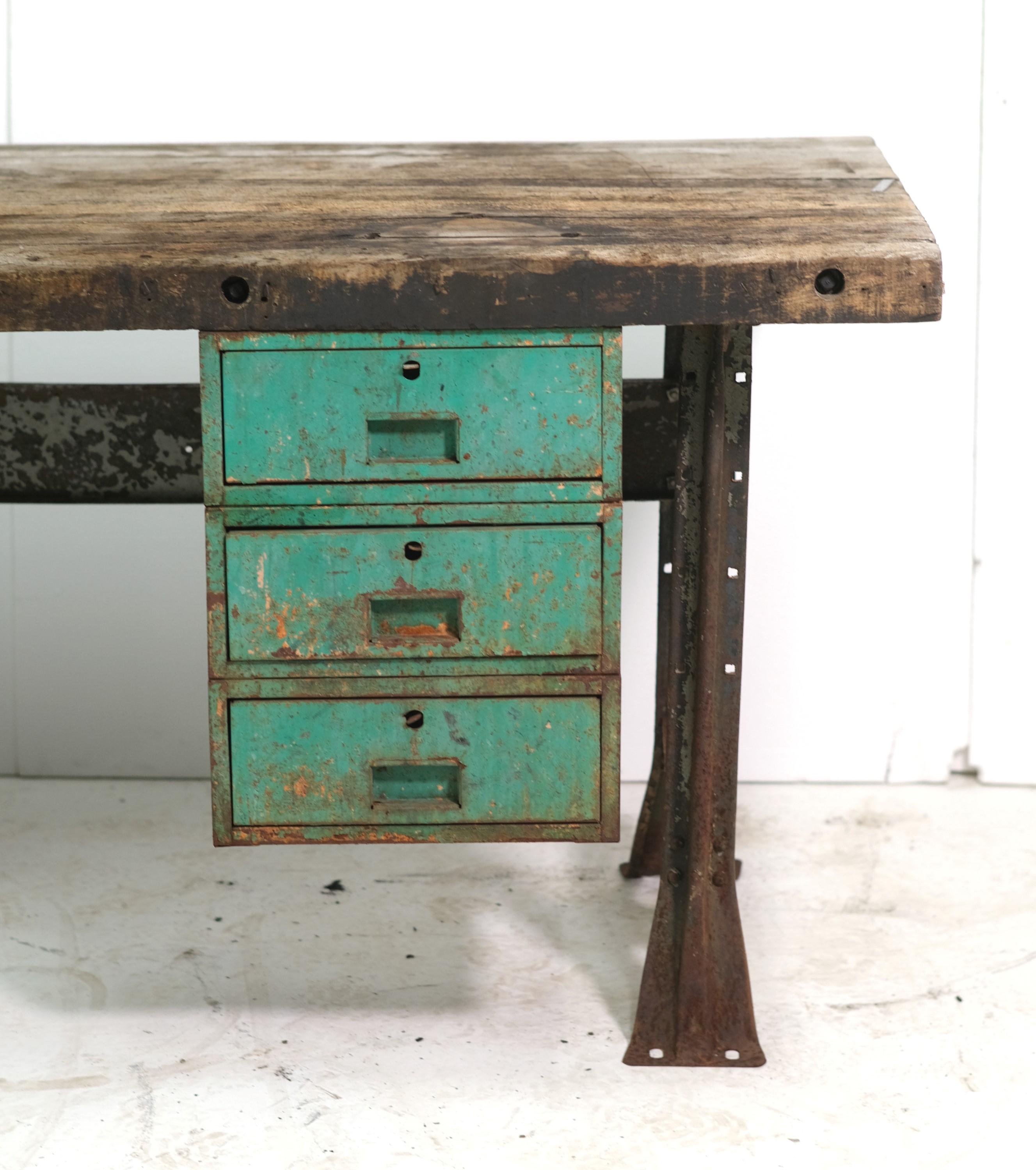Mid-20th Century heavy duty industrial work table. Has original paint and patina. Solid pine top with a steel industrial base and six drawers, three on each side. Please see the images. This can be seen at our 400 Gilligan St location in Scranton,