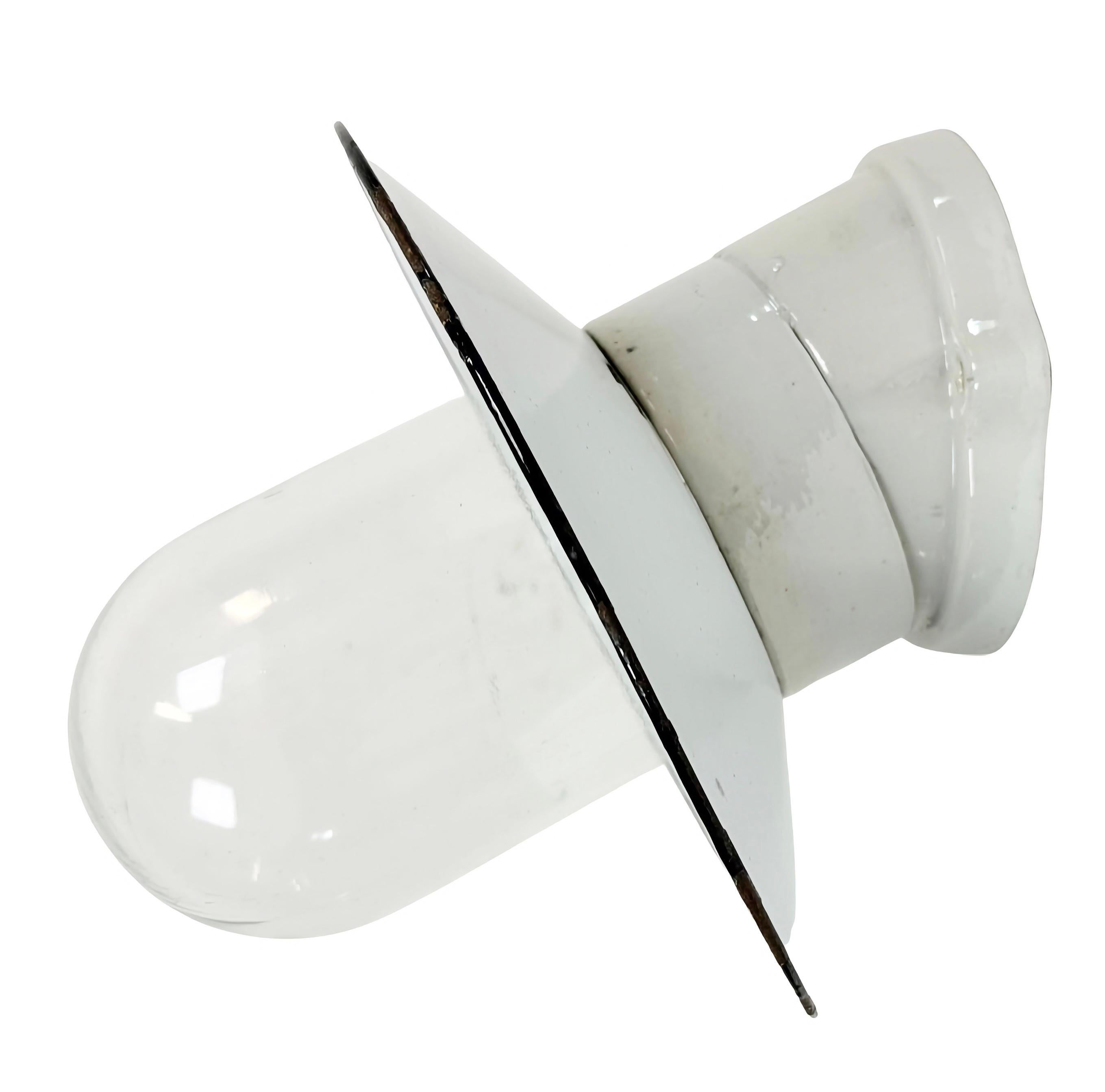 Vintage Industrial light made in Poland during the 1960s. It features a white porcelain wall mounting,a white enamel shade and a clear glass cover. The socket requires E27/ E26 light bulbs. New wire. The weight of the lamp is 1.3 kg.