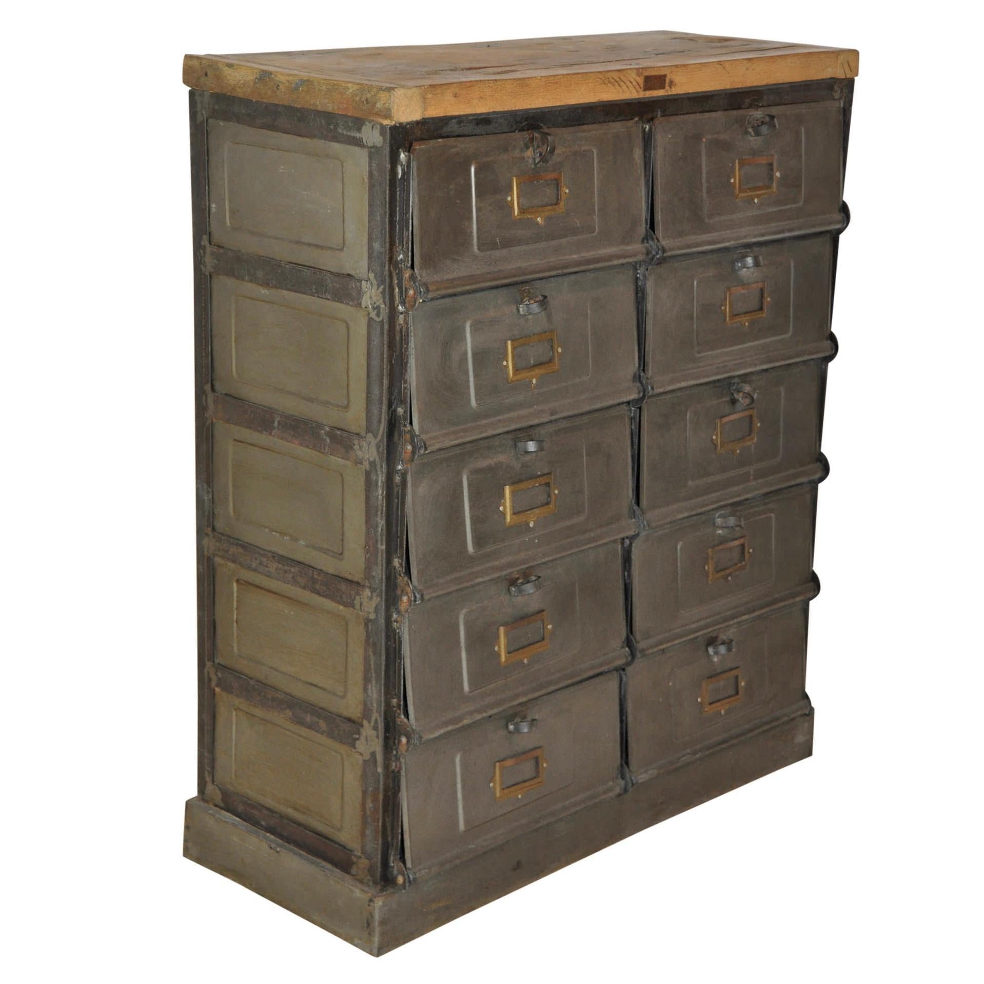 A post office, hotel, factory, or business likely used this ten door console for mail. The doors are hinged at the bottom and latch/unlatch by turning the looped handles. Brass card or name holders are on the front of each door. Compartment sizes