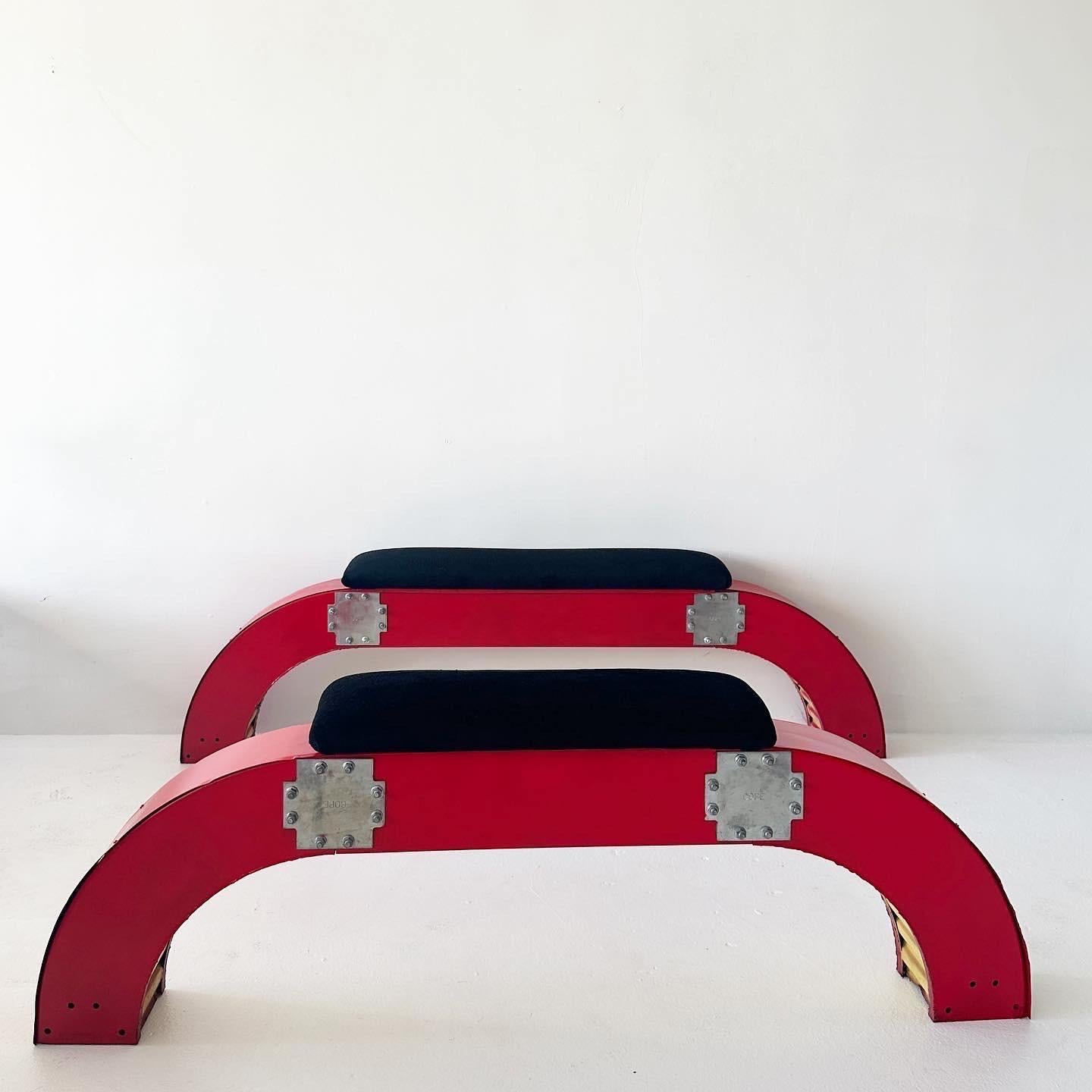 Two waterfall industrial metal benches made in the 1990s for an underground dance music record store on Melrose Avenue in Los Angeles called Beat Non-Stop.

These have been repainted red and the seat upholstery has been redone with a beautiful black
