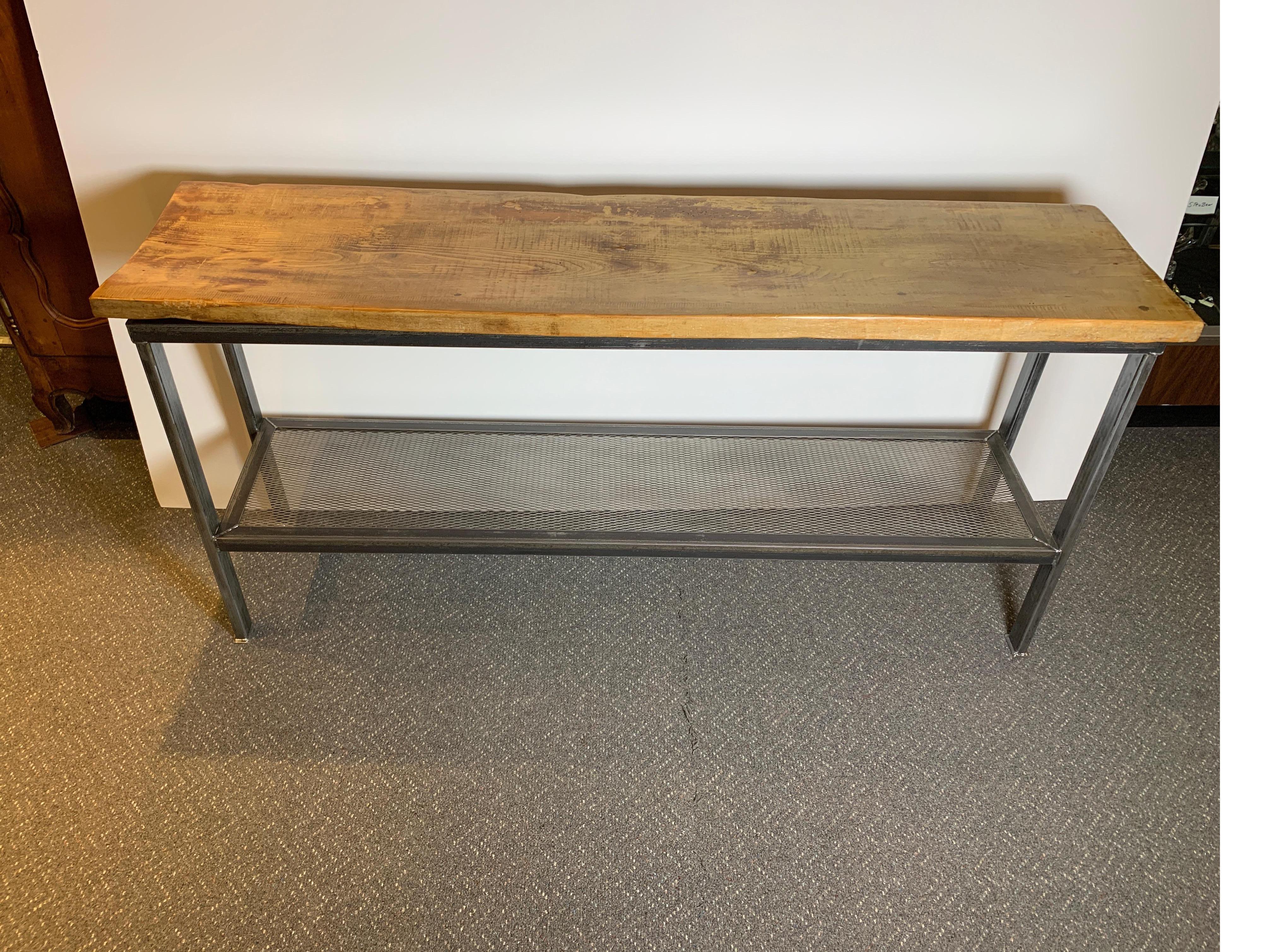 This well-designed metal and wood console table measures 72