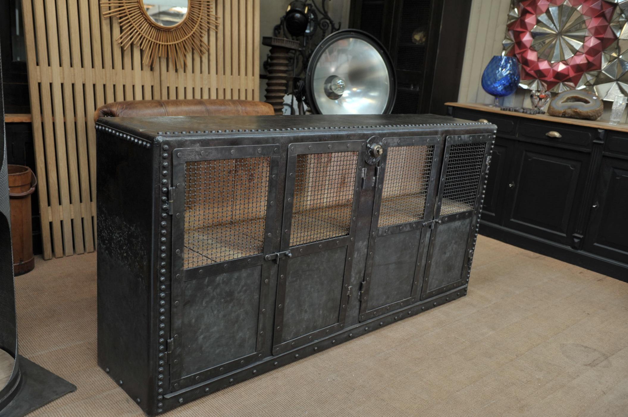 French factory tank circa 1900 in riveted iron in 4 mesh doors Industrial credenza cabinet with pine inside shelves, all hand polished finish, very good condition.