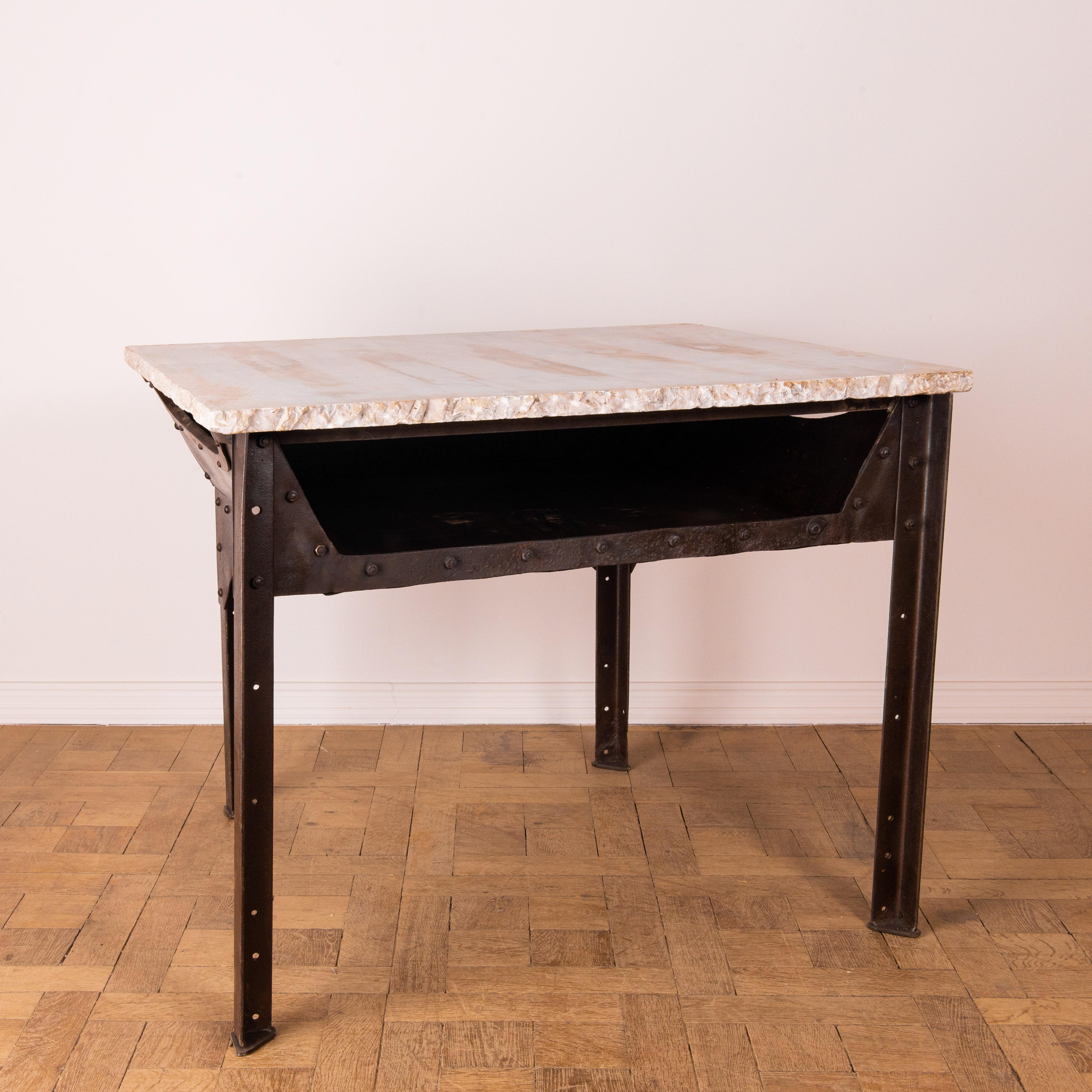 This unique table comes from Czech Republic, circa 1920. These limited production work pieces were built for factory specific settings, featuring robust and wear resistant iron construction. The riveted steel frame gives ample support for frequent
