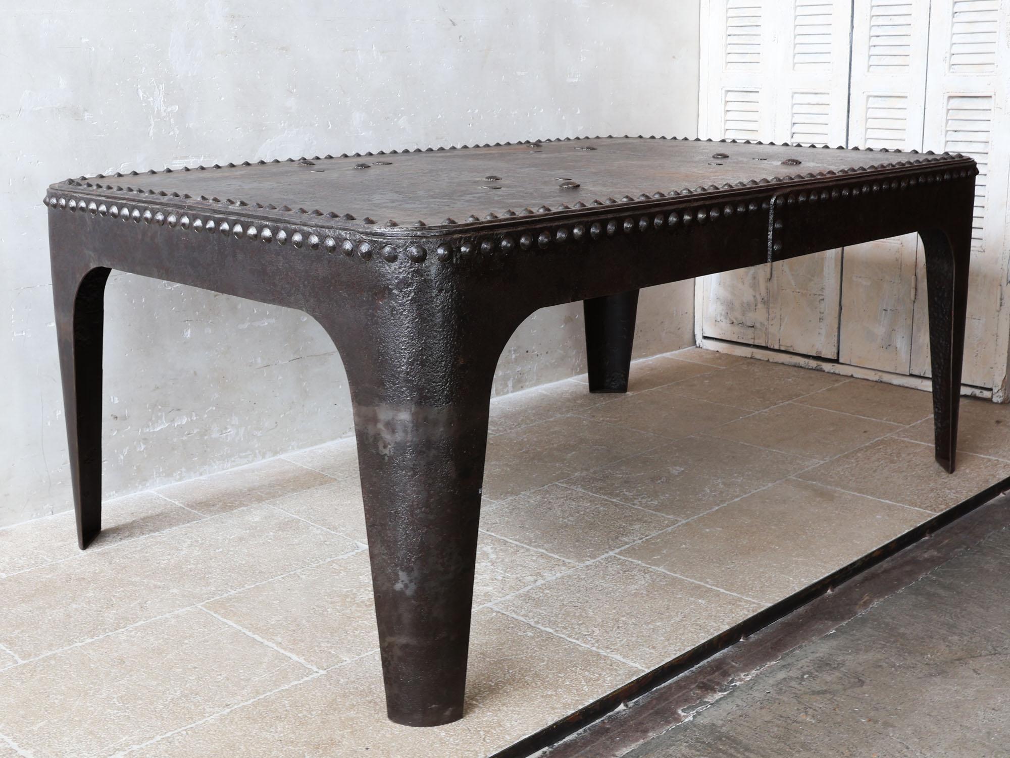 Industrial Tank Table, a robust piece crafted from an antique riveted metal water tank boasting a beautiful aged patina. Originally used in 19th-century France, these tanks carry a rich history that adds character to any space.

Ideal for large
