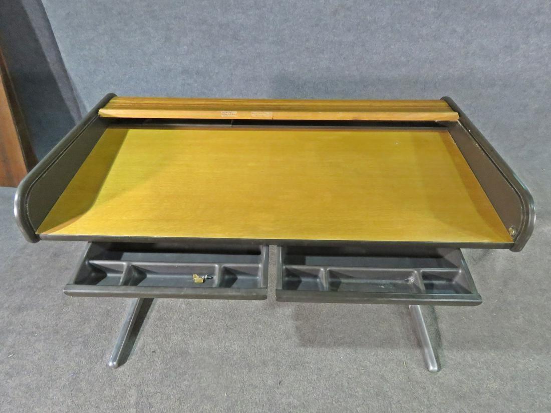 A vintage Industrial roll top desk in the style of Herman Miller, featuring a sliding cover that easily rolls up to reveal the desk surface. Please confirm item location with seller (NY/NJ).