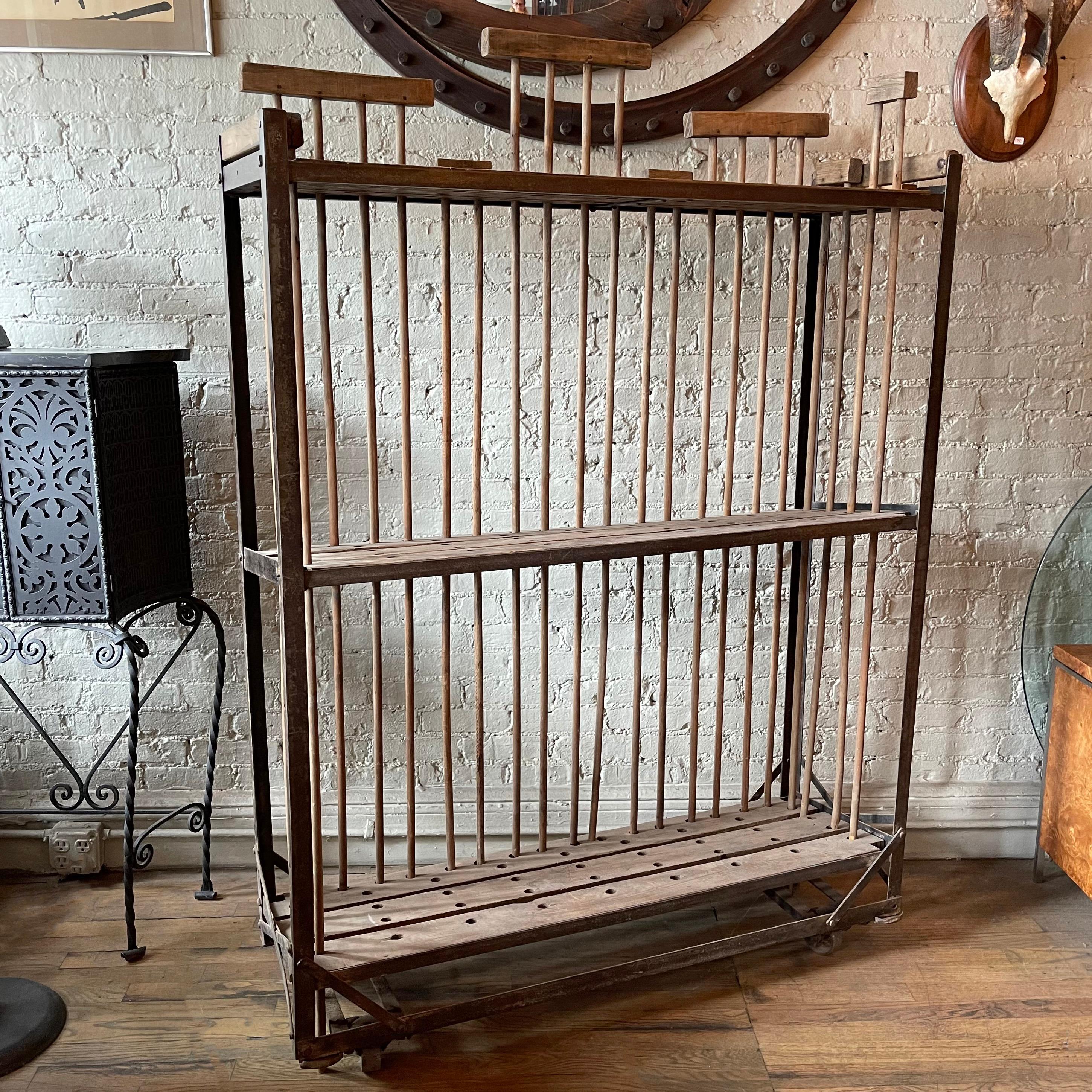 Rustic, industrial, rolling rack features 3 perforated shelves in an angle iron frame. The top shelf is 58 inches height. The bottom 2 shelves are slanted toward the back approx an inch.