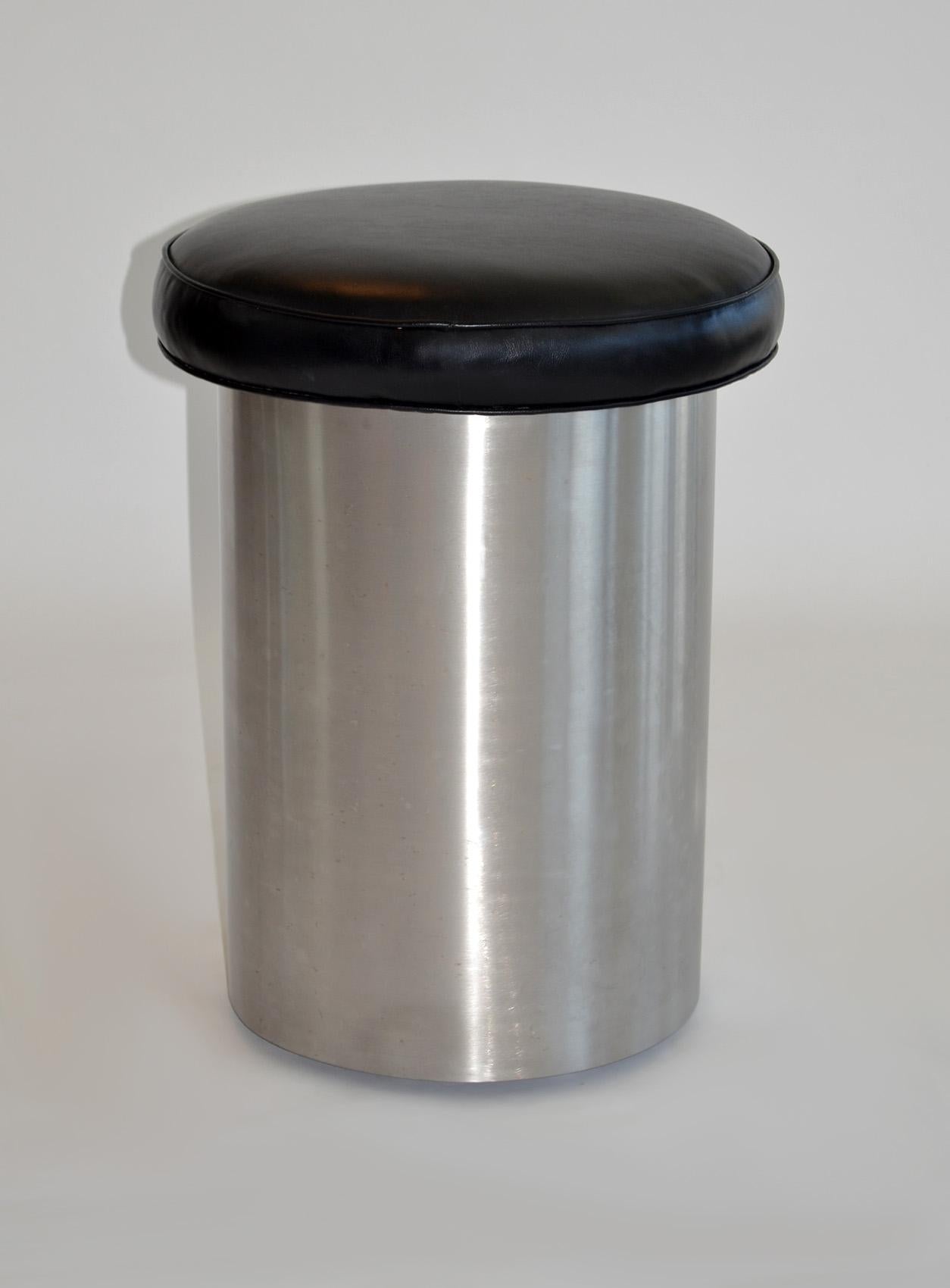 Industrial Round Rolling Steel Stool or Seat with Cushion Manner of Brueton
Minimalist construction on heavy duty casters, satin stainless steel topped with a welted, black vinyl cushion. Cushion measures 18