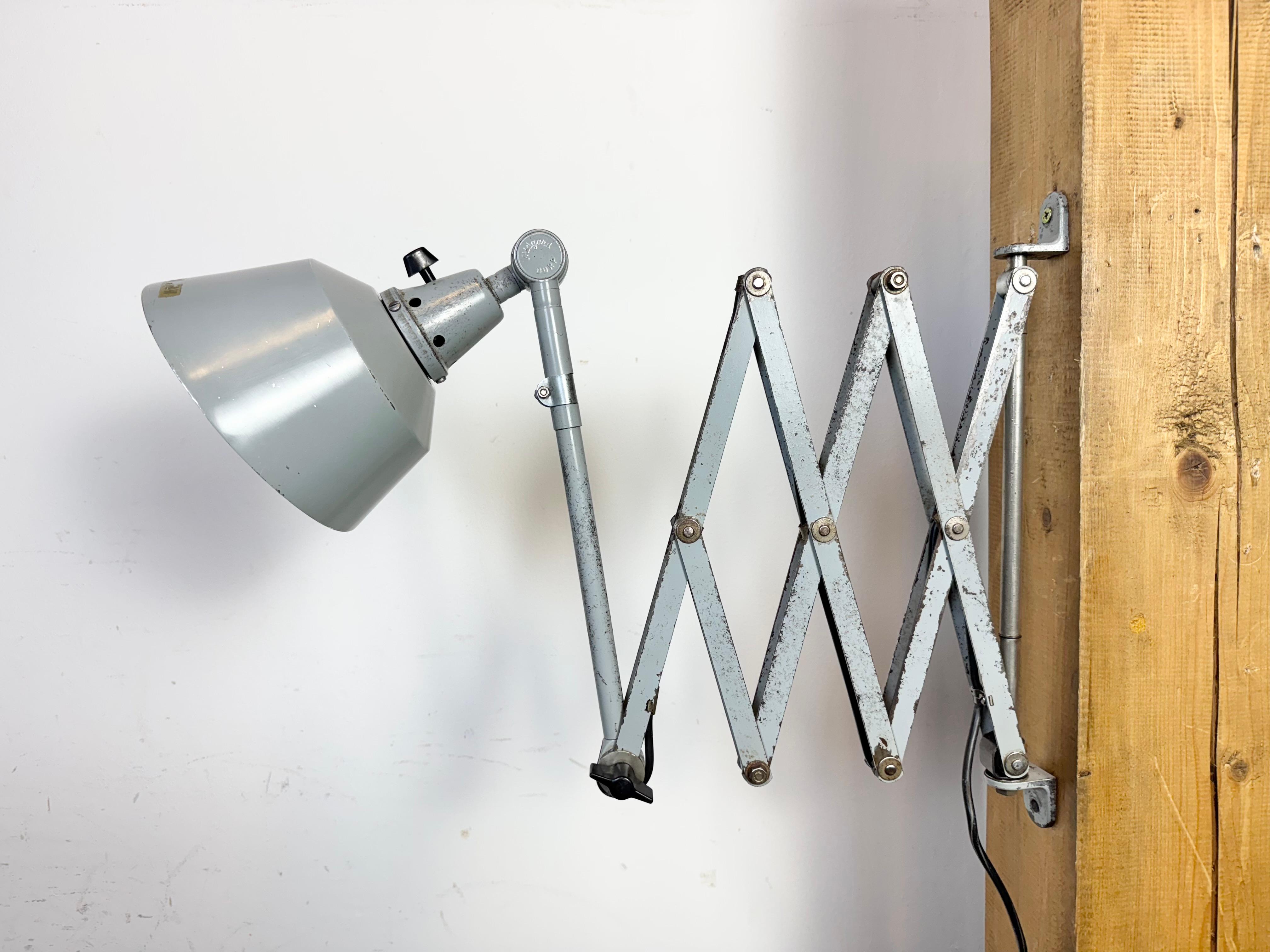 - Industrial workshop adjustable DDRP scissor wall lamp produced by Midgard in Germany during the 1930s.
- Designed by Curt Fisher.
- Metal shade
-  Grey iron scissor arm is extendable and can be turned sideways
- DDRP sign
- The socket requires