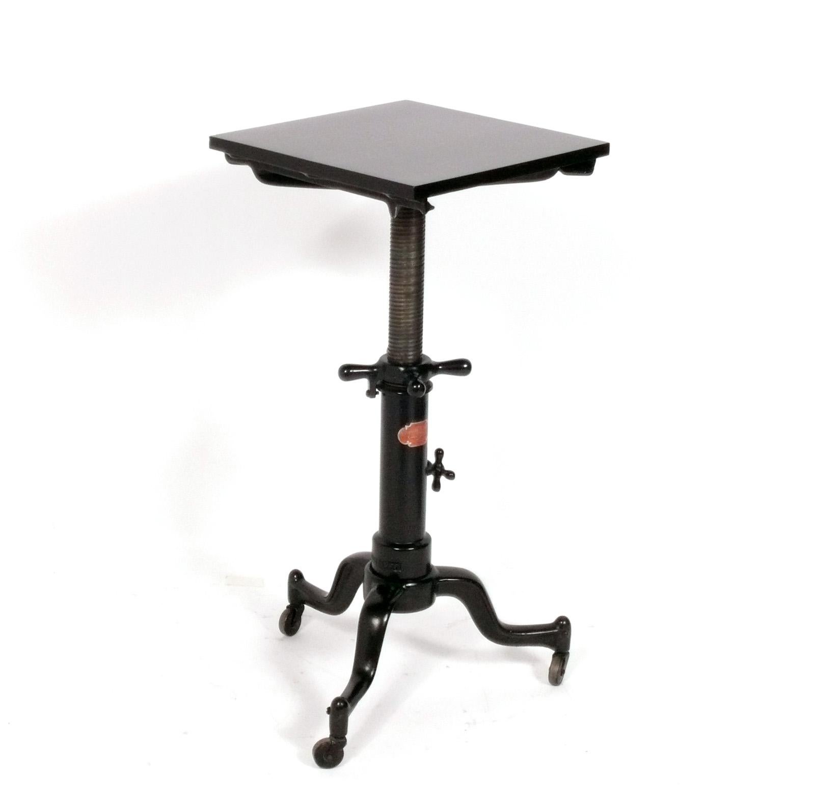 Industrial sculpture stand, American, circa 1930s. This piece was originally probably used as a typewriter stand, but would work well as a sculpture stand, nightstand, or pedestal. It is called the satellite table, and was made by the Adjustable