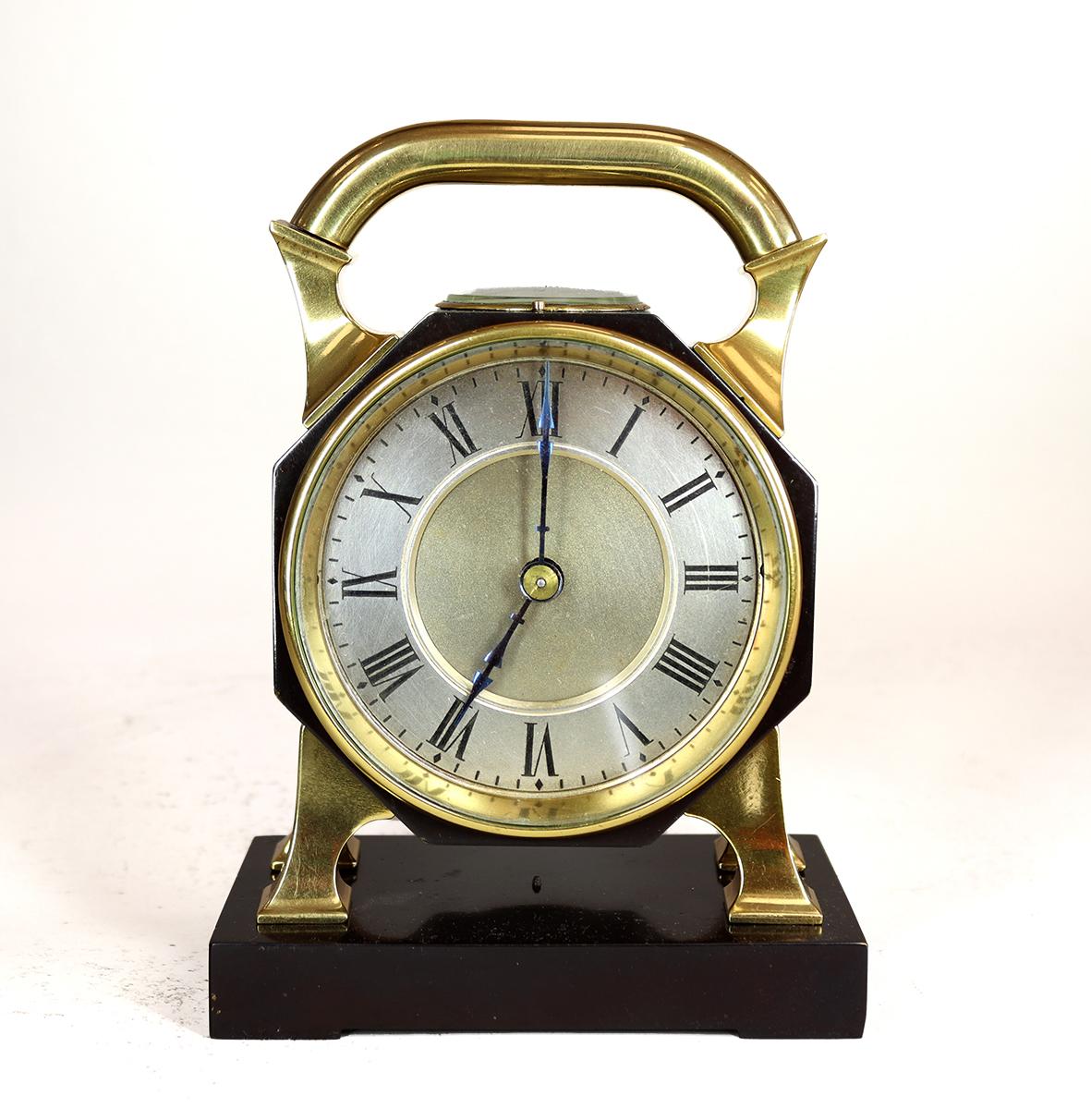 A very stylish late nineteenth century desk clock with integrated compass, reminiscent of the Industrial series of clocks by Andre Guilmet. The eight day movement governed by a cylinder escapement, behind a two tone roman dial with matted central