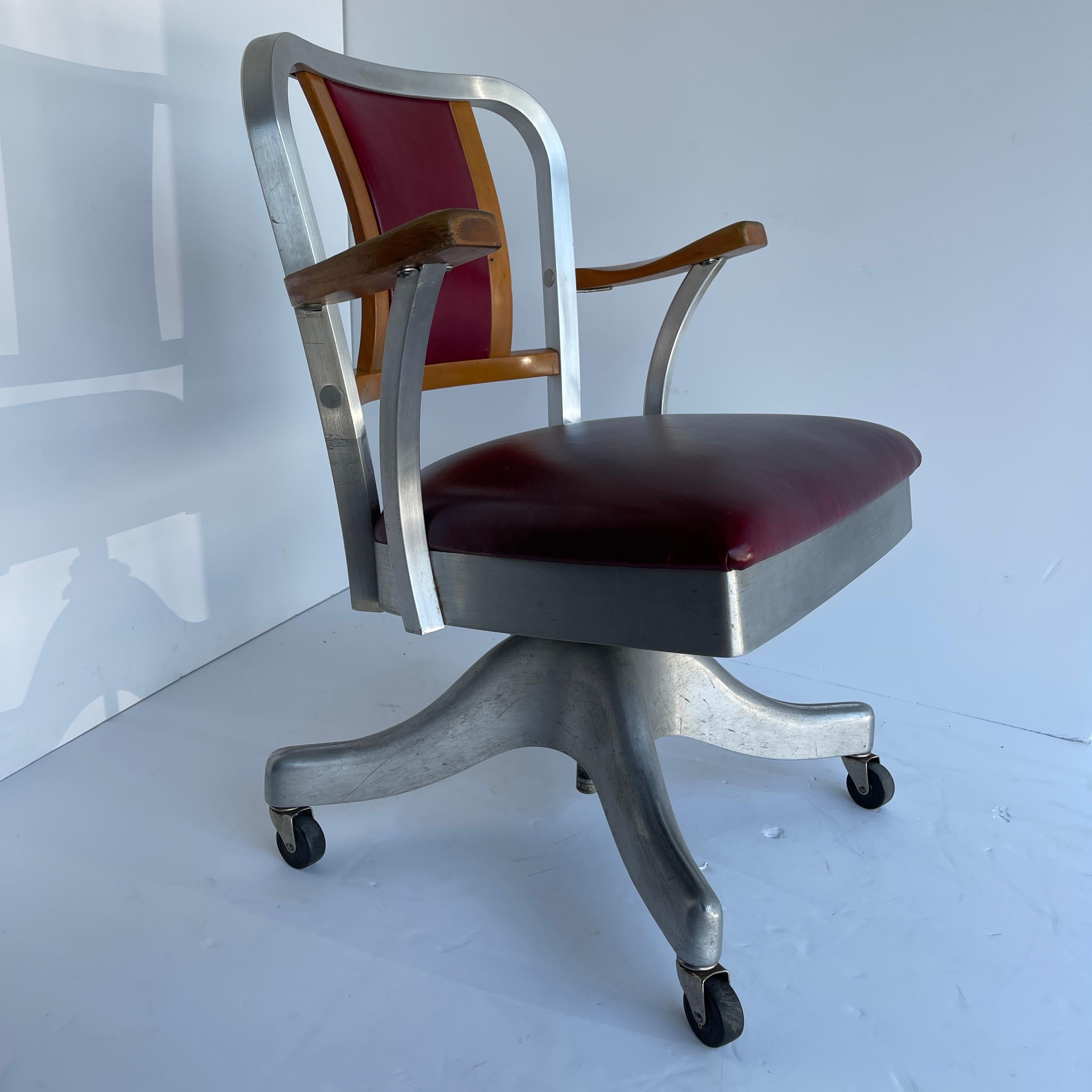 Mid-Century Modern desk chair, by Shaw Walker in aluminum and red leather.
This chair is a beauty! The newly reupholstered butter soft burgundy leather on the back and seat make this solid chair elegant and stylish. The chair swivels smoothly.