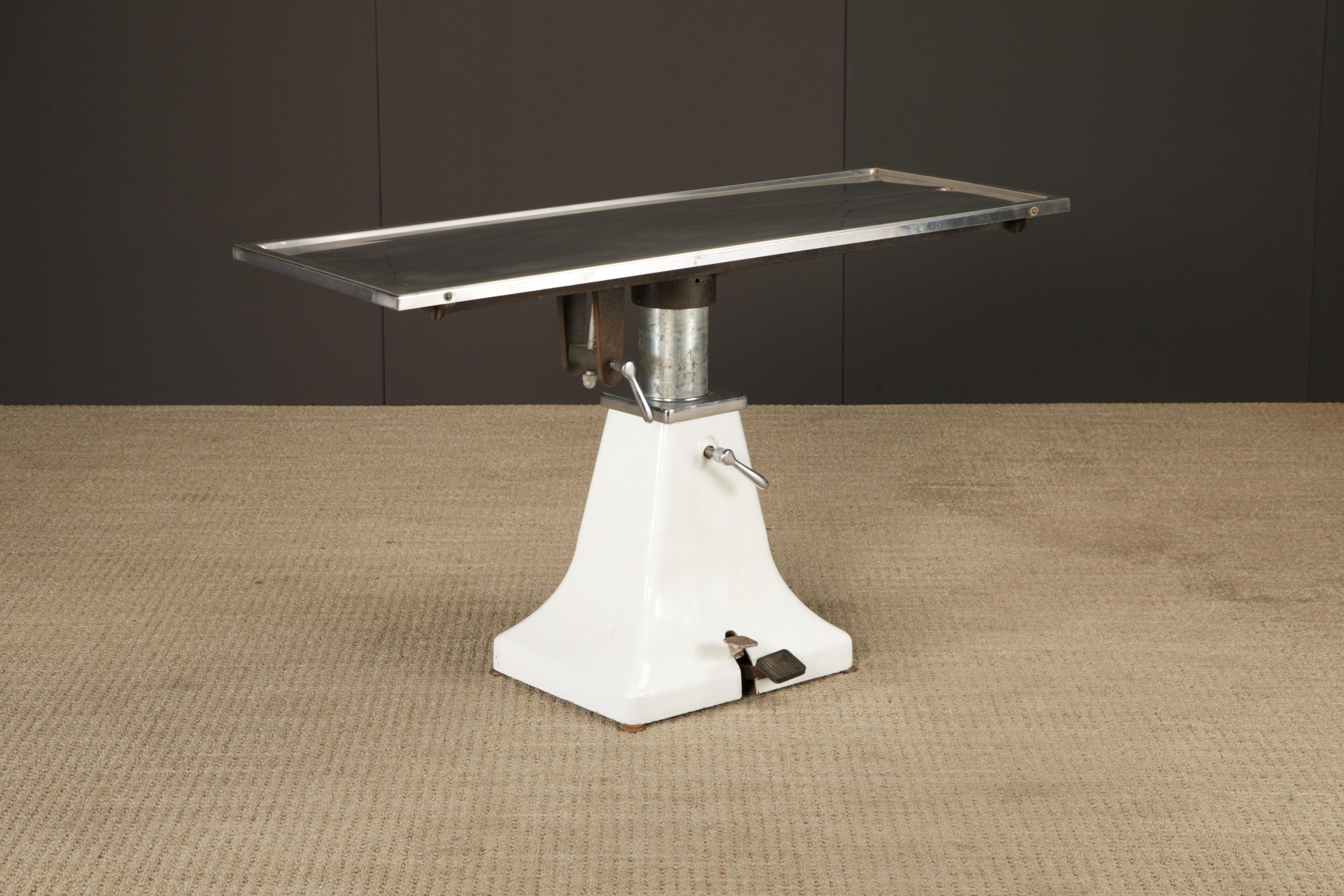 A rare and visually striking vintage hydraulic surgical table by Shor-Line, manufactured in the United States in the late 1950s. This industrial artifact was originally designed for veterinary surgical procedures, a utilitarian marvel of mid-century