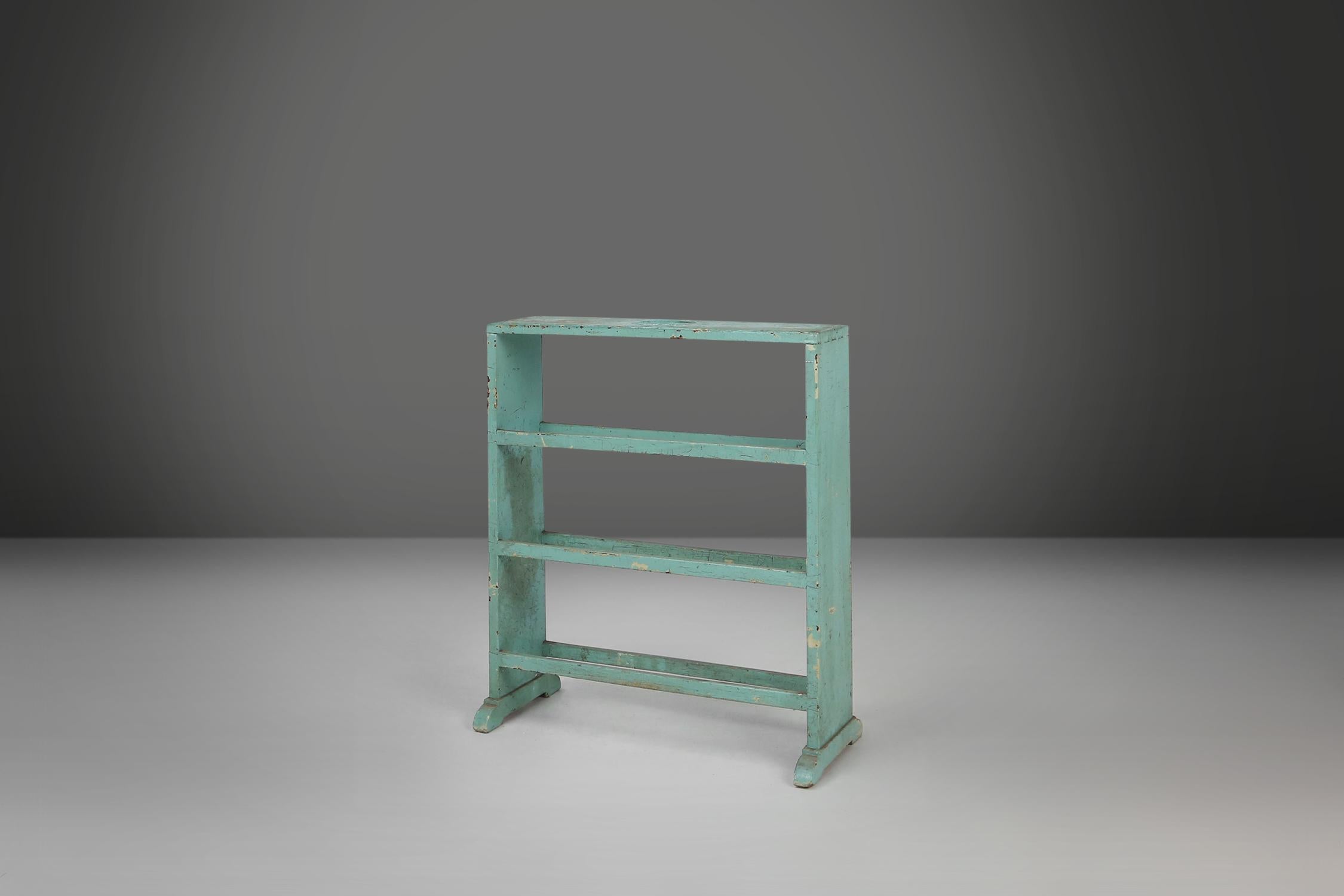 Belgium / 1920s / lacquered wood / mint /  mid-century / industrial / vintage / design

Industrial mint-colored rack or small bookcase with straight legs and nice sturdy feet and decorative handles on the top. The antique storage piece is made of