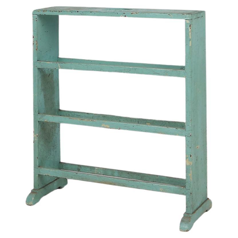 Industrial small mint-colored rack or bookcase with 4 shelves