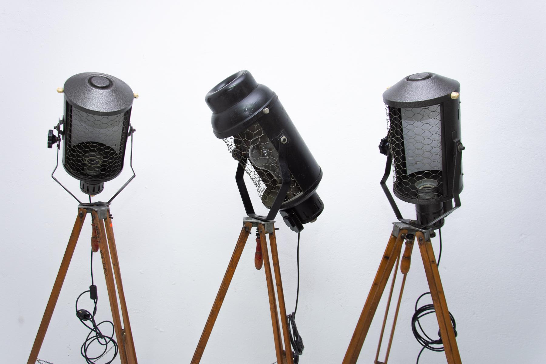 Set of vintage Industrial spotlights on a wooden tripod. They were made in the former Czechoslovakia in the 1970s. Adjustable height and angle. It features an original large rounded shade. Provides a high level of lighting. An outstanding and