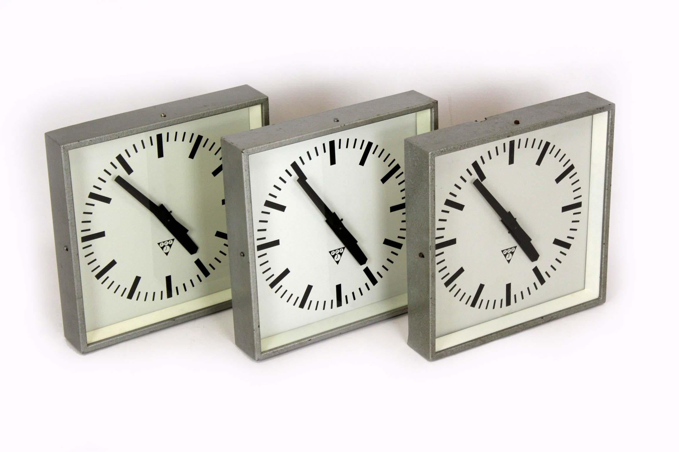 Conjunto de tres relojes ferroviarios cuadrados fabricados por Pragotron en la antigua Checoslovaquia. El mecanismo del reloj se ha sustituido por uno nuevo, que funciona con una pila AA.
