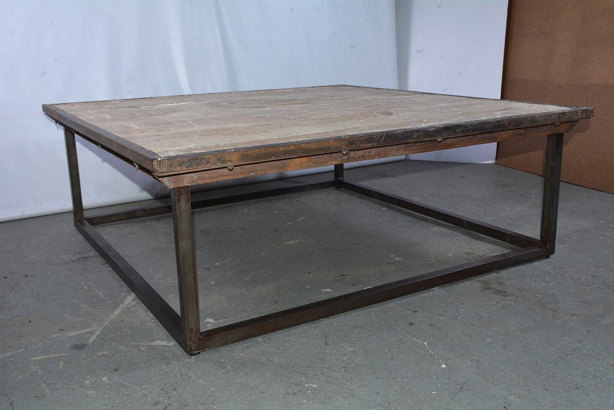 Tabletop is made from salvaged wood pallet that sits on a new iron base cocktail table. Sturdy and rugged, perfect for a loft or Industrial style interior. The combination of the Industrial and contemporary metal base makes this table a modern mix