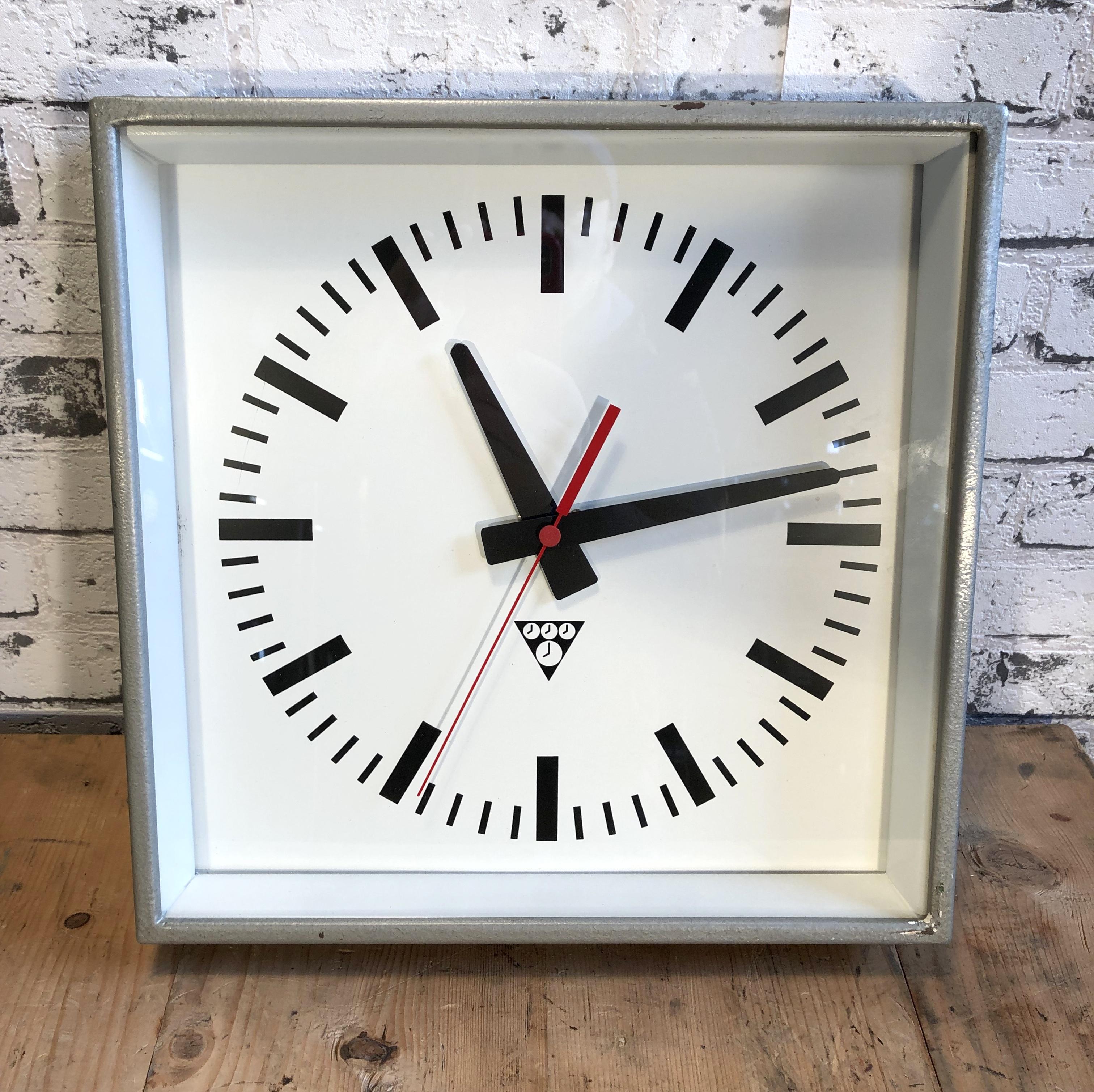 Clock made by Pragotron in former Czechoslovakia during the 1970s.Was used in factories, schools & railway stations. Grey metal hammer paint body, aluminium dial and hands, clear glass cover.
This item has been converted into a battery-powered