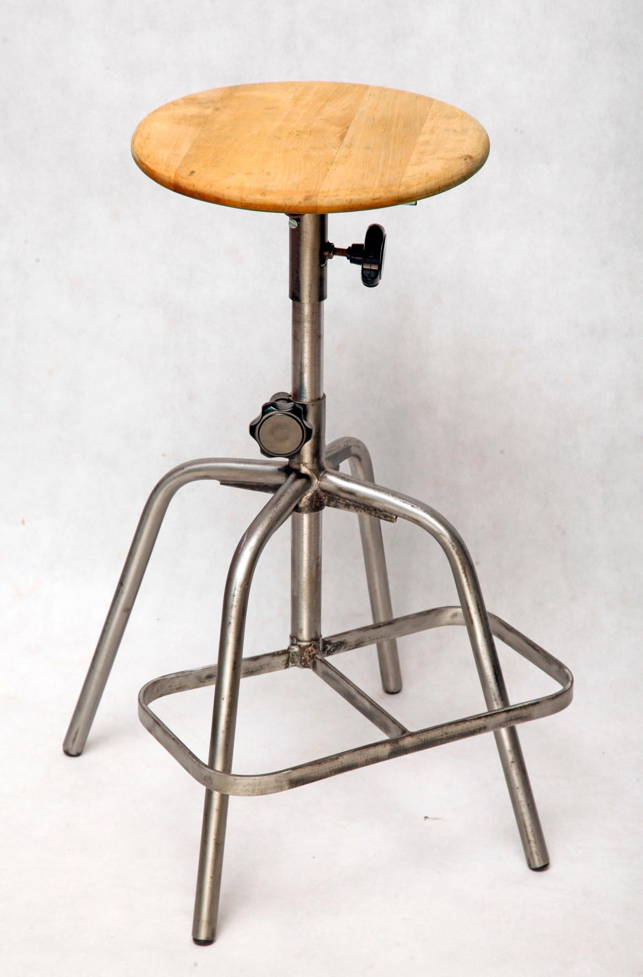 The metal stool was used in workshops in Poland in the 1970s. The whole construction is metal (steel), only the seat is wooden. Stool has adjustable seat height in the range of 59-82 cm. All you need to do is unscrew the black plastic knob. An