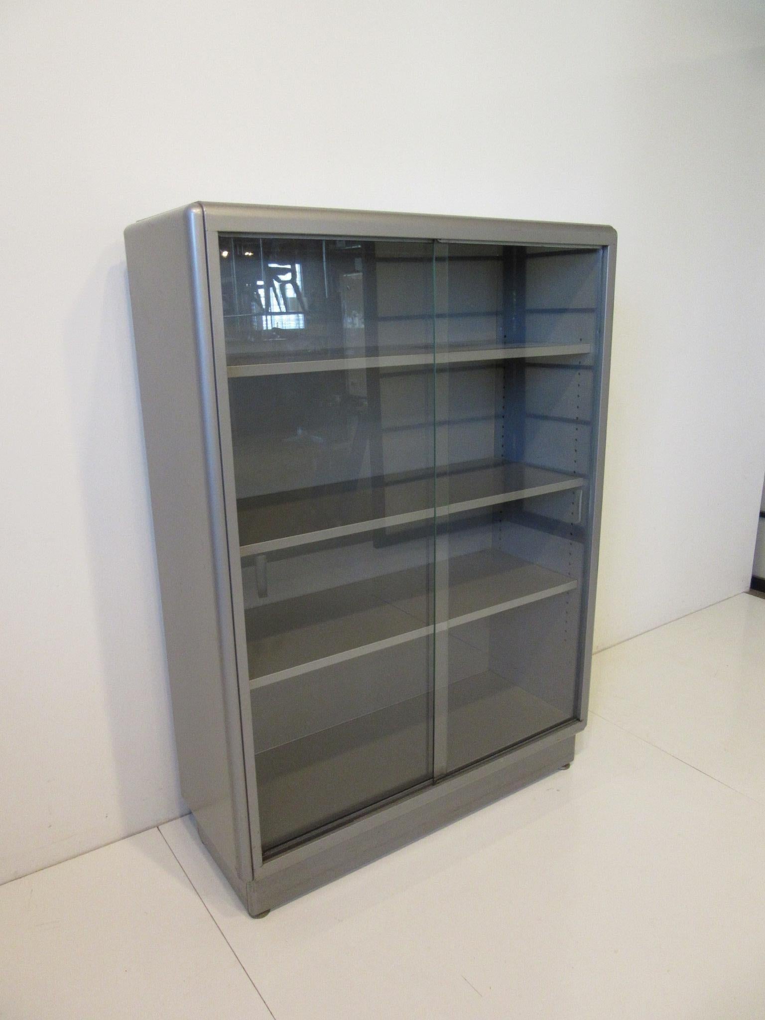 20th Century Industrial Streamline Metal / Glass Bookcase by ASE Equipment