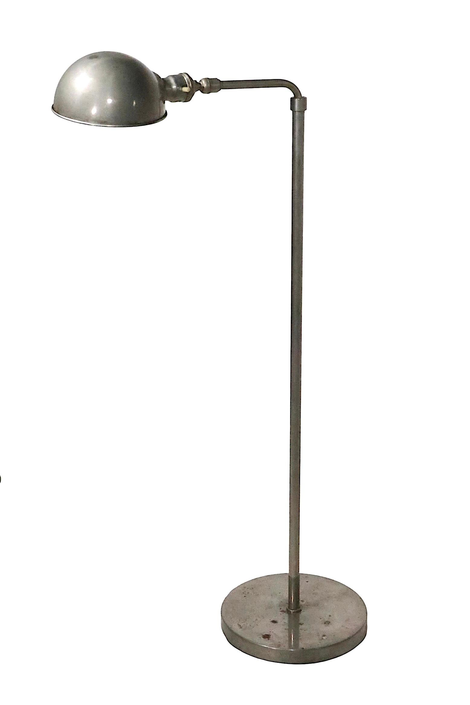 Exceptional Industrial style reading, pharmacy floor lamp, in unusual nickeled metal, and original gray paint finish. The lamp features an adjustable center post which allows the light to be extended from 36