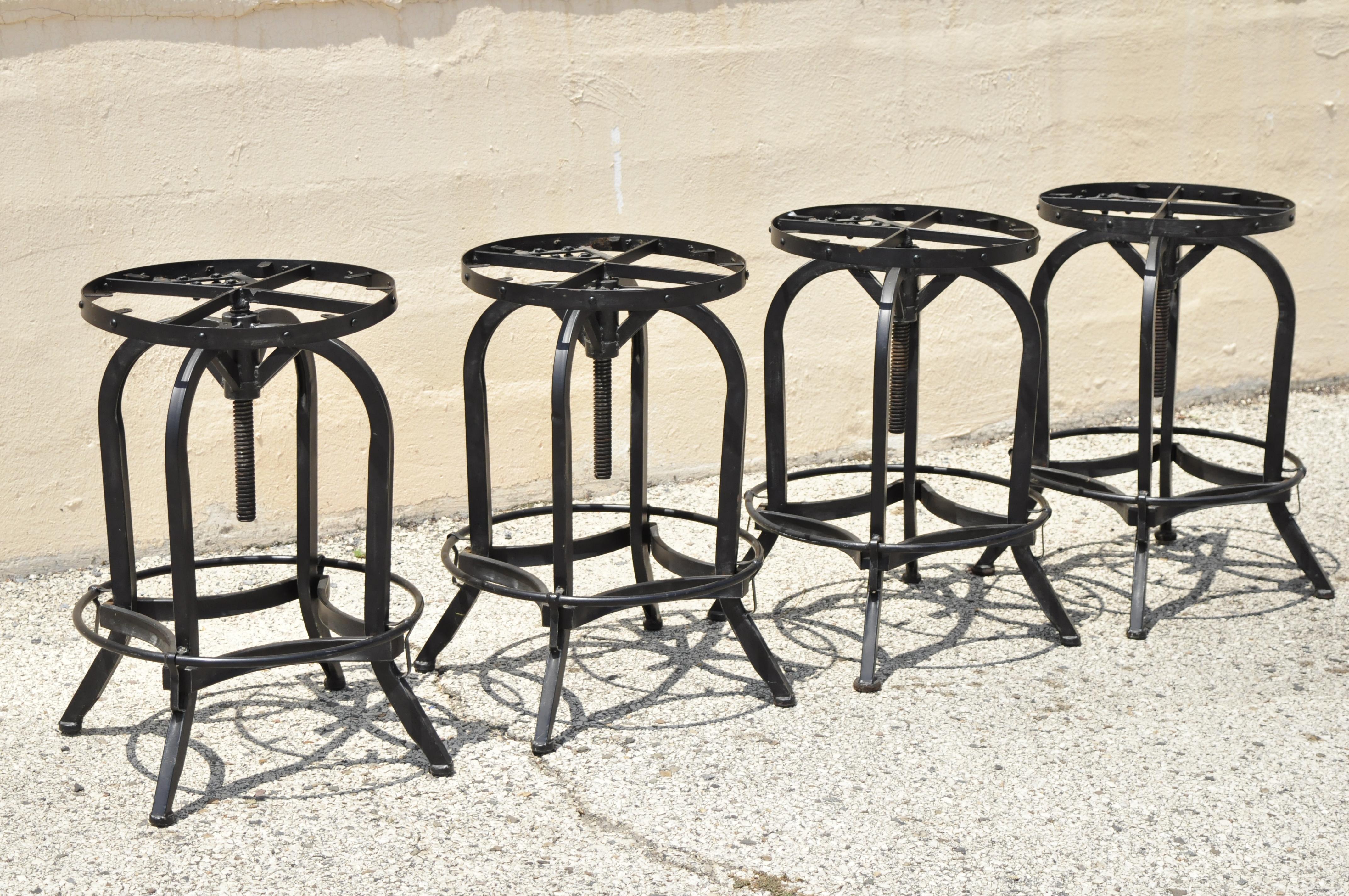 Industrial Style Iron Frame Adjustable Height Swivel Bar Stools - Set of 4. Item features (4) adjustable height stools, iron construction, swivel seat, great style and form. Circa 21st Century, Pre-owned. Measurements: 26.5 - 33