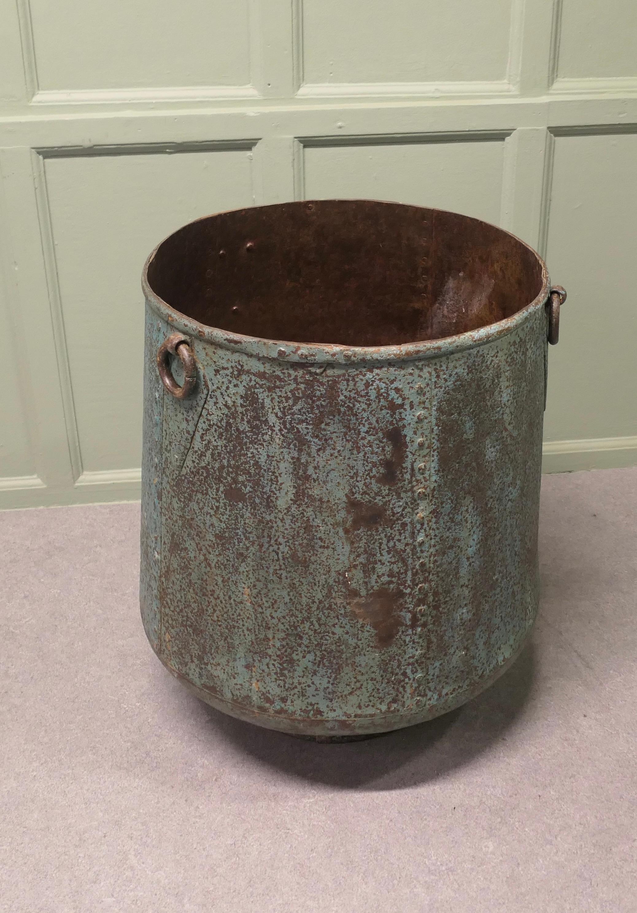 Industrial Style Iron Log Bin, or Large Planter


This is a spectacular piece, it is made in riveted iron panels and has an industrial look, it has 3 ring handles and is beautifully patinated in a verdigris shade of blue.
The Log bin or tree planter