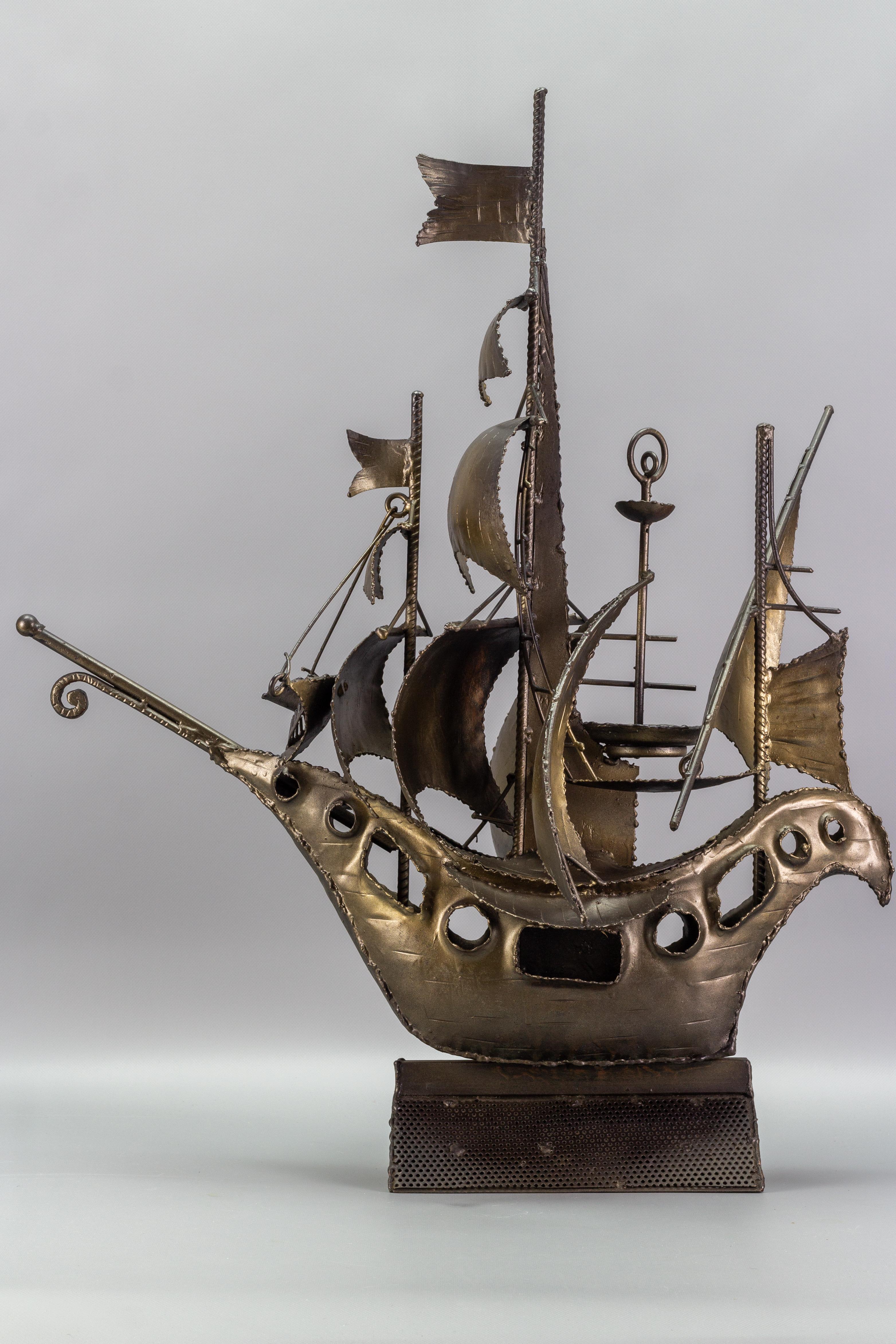 Unique and very decorative industrial-style sailing ship sculpture made of metal in the 1970s, Germany.
This amazing handcrafted welded metal object is highly decorative, placed on a metal stand that allows to place it for display purposes in any