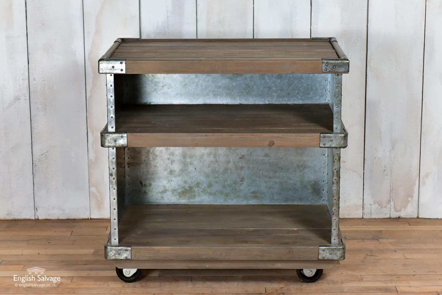 New Industrial style shelving unit on wheels. Rivited metal sides and back with pine planks. Solid construction.