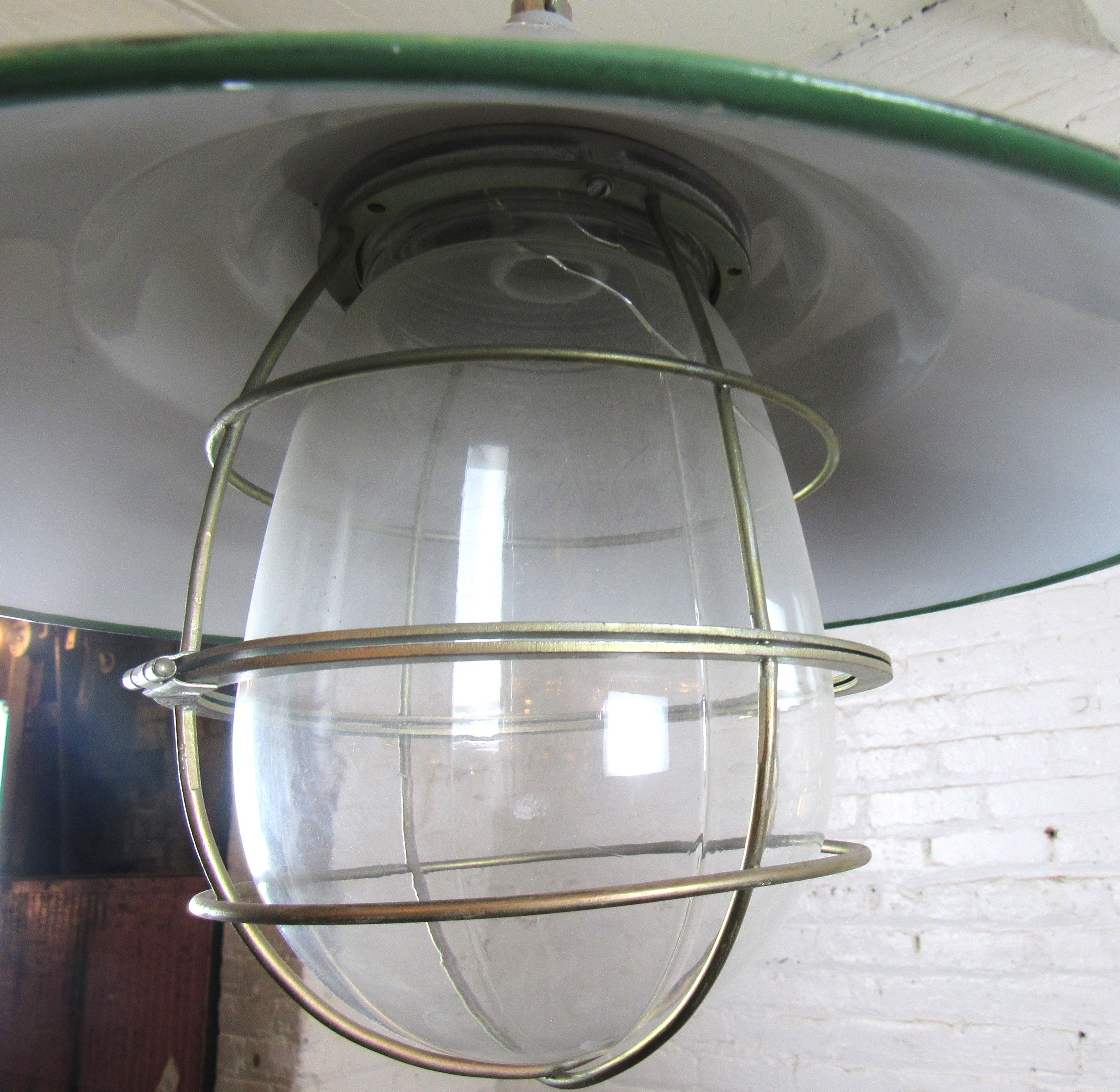 Round metal canopy pendant light with wire guard. 
Location: Brooklyn NY.