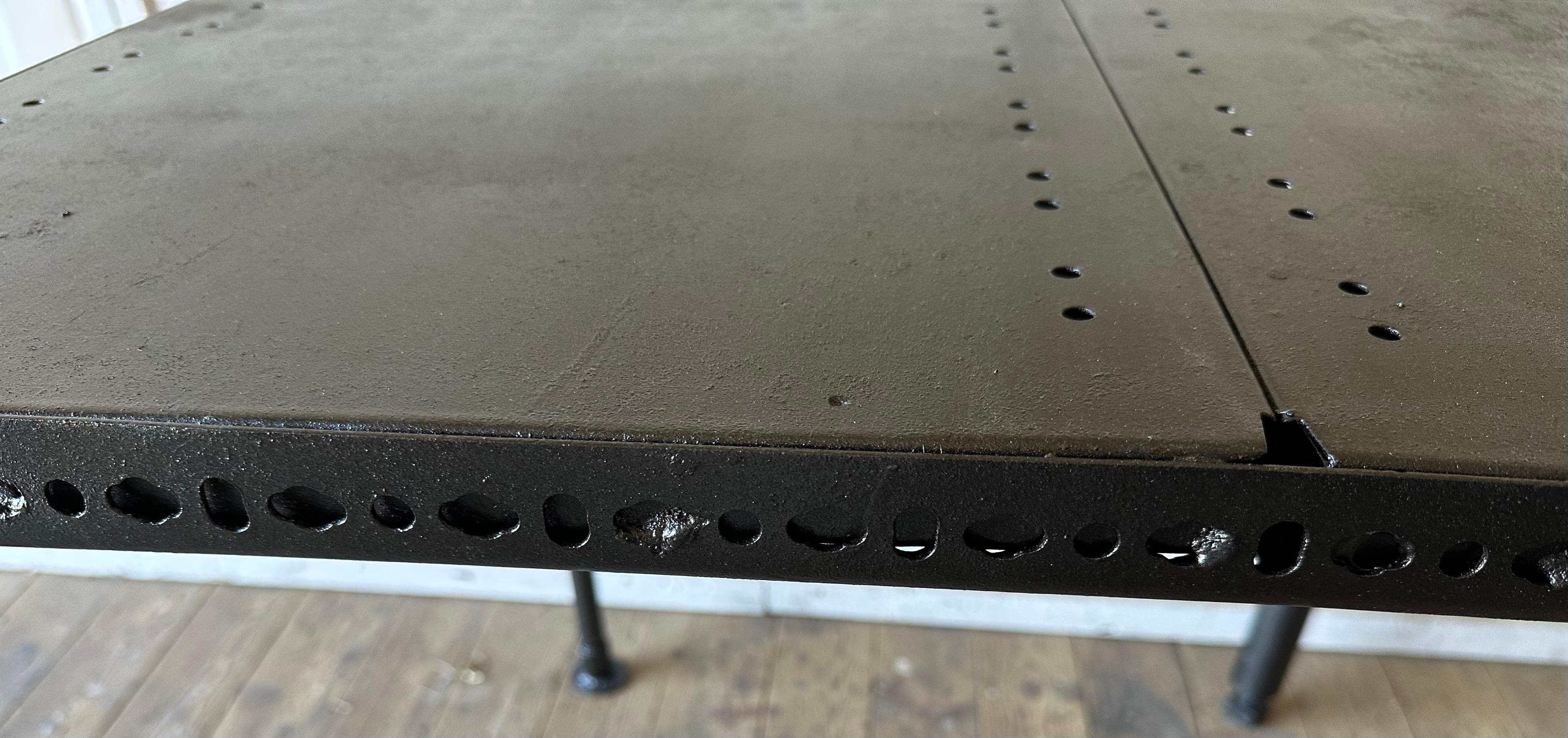 An unusual Industrial style metal table that can be used in a wine tasting cellar or used for drafting or work table.
An interesting design with cutouts and 4 different style but harmonious steel legs making it a wonderful conversation piece.