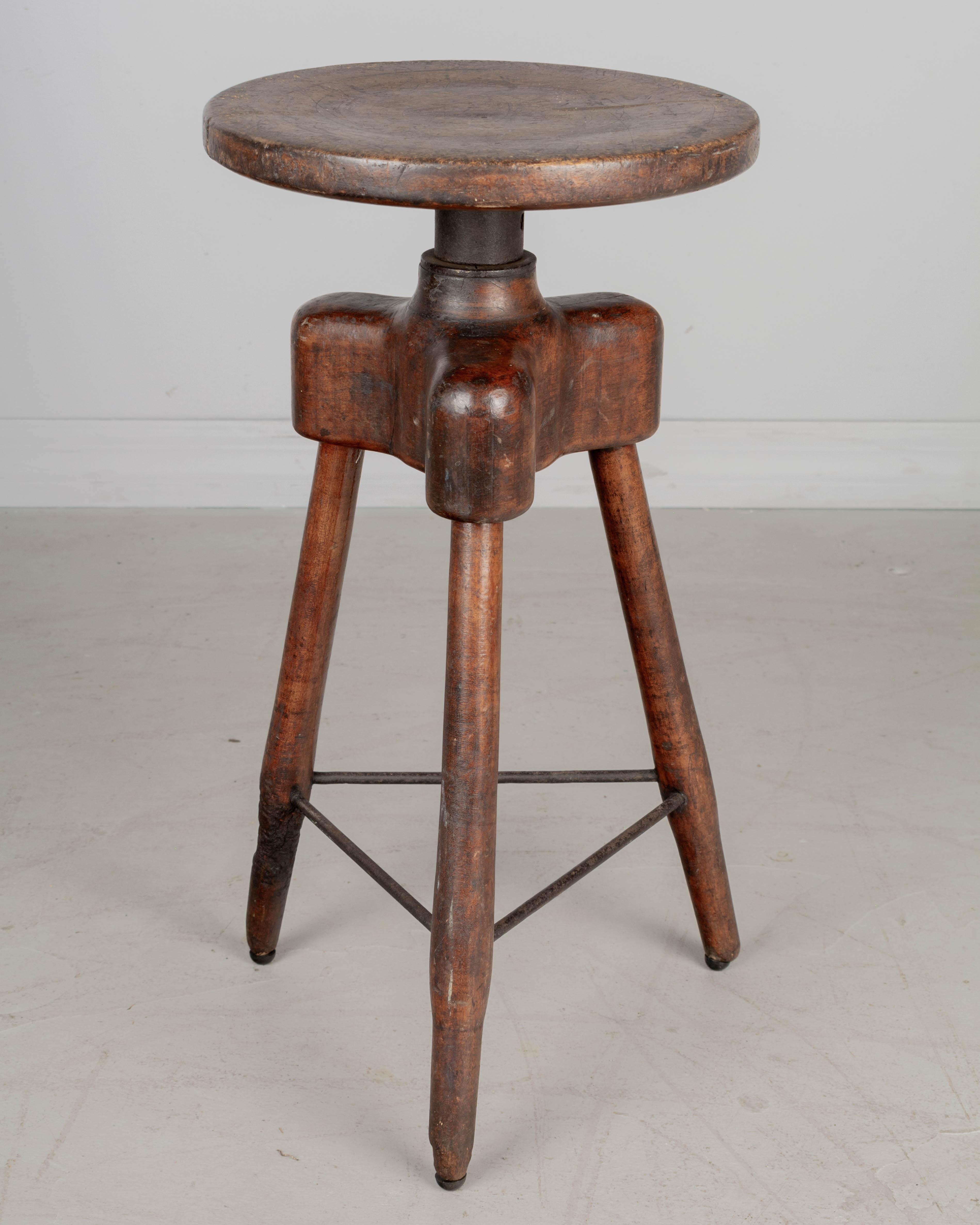 An Industrial swivel work stool, hand-crafted of solid maple with sturdy tripod base joined with iron rods. Nice rustic patina. Perfect for use as a drink table. Circa 1900.
20