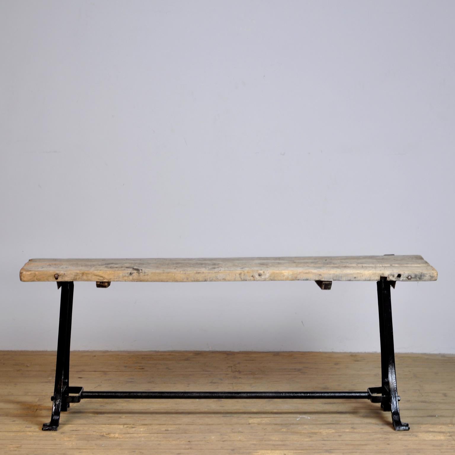 This industrial table is made from an old cast iron machine base and a weathered wooden top.