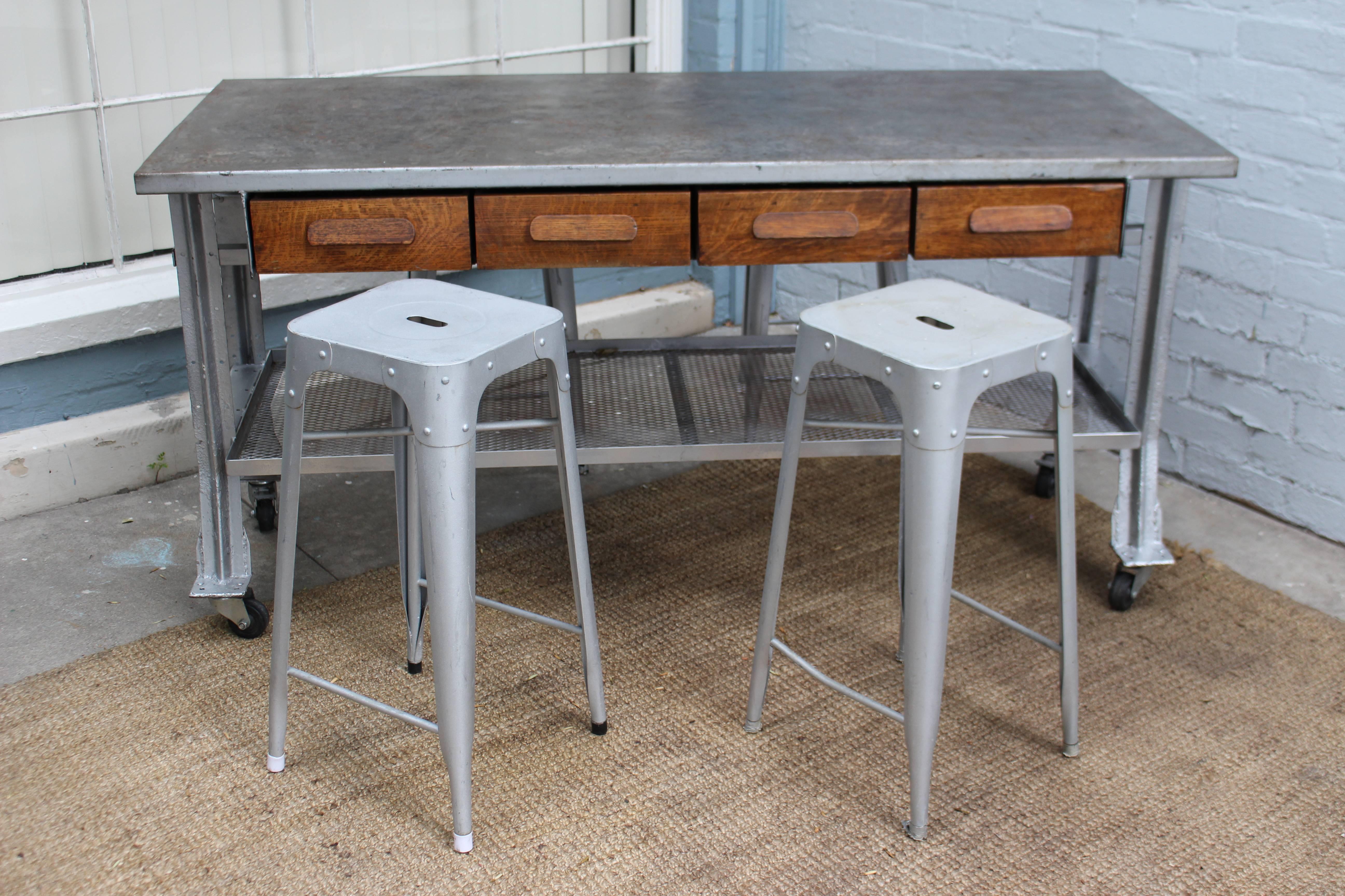 1960s Industrial table and four chairs, table can be used as a kitchen island or work table because of the wheels it can be easily move around the loft or kitchen. Also four antique oak wooden drawer as artist touch.
Chairs dimensions: H 30, W