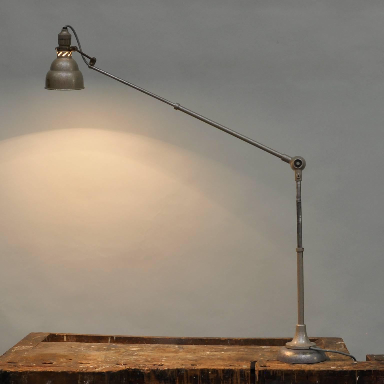A Industrial lamp with a heavy iron base. The lamp is fully adjustable and is from circa 1955. Produced by Lumina Brevete.