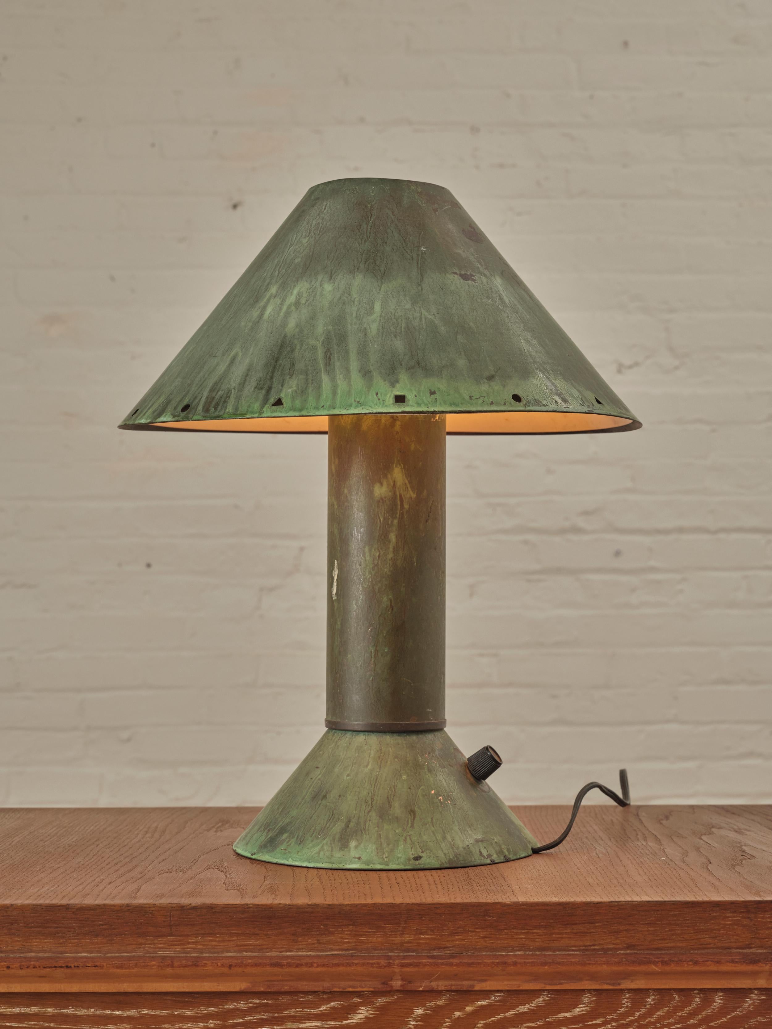 Industrial California Table Lamp by Ron Rezek. This lamp exhibits classic form and motif of the Memphis era in oxidized, patinated copper. White enamel reflector shade attaches to base, outer copper shade rests on top making the shade